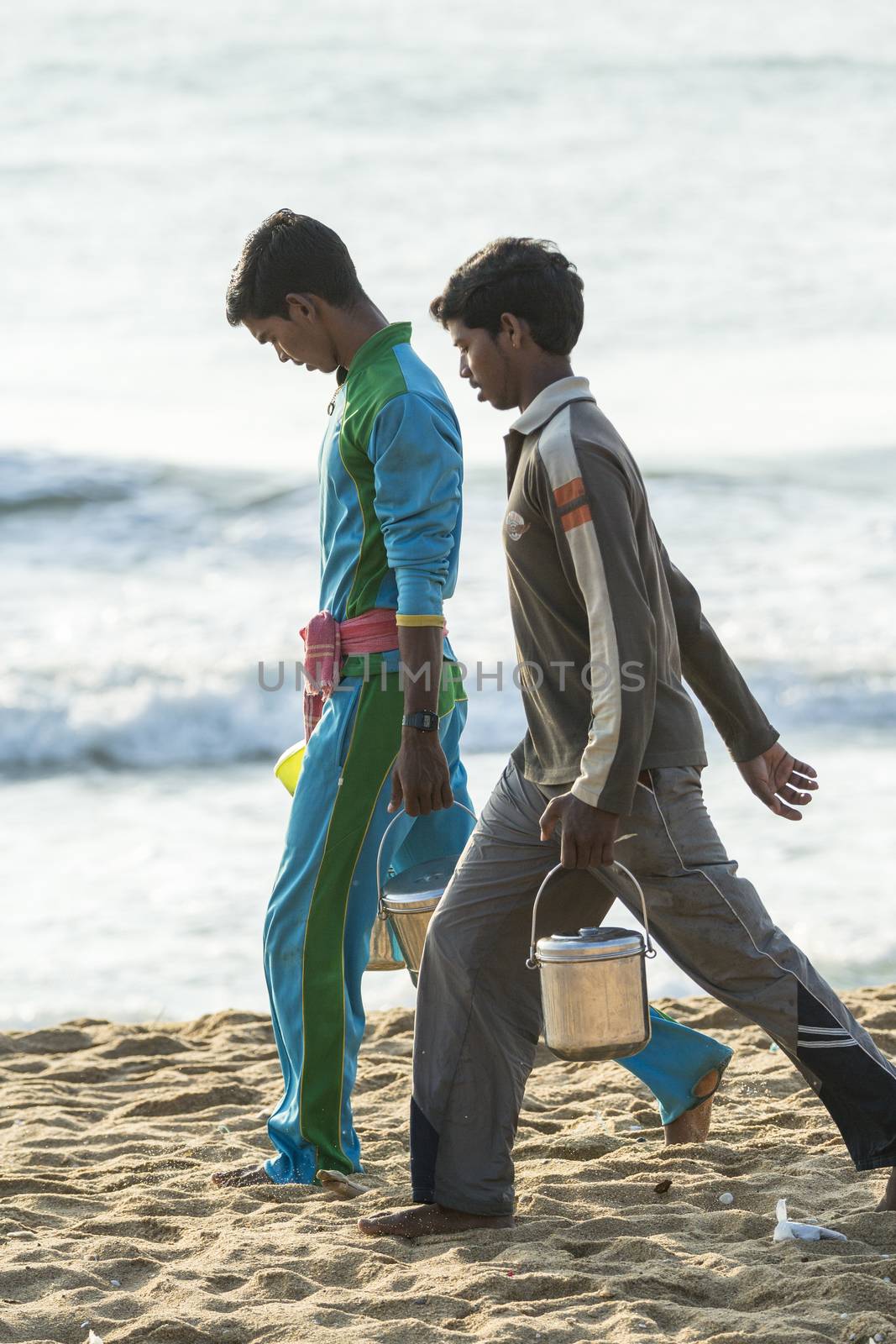 Pondichery, Tamil Nadu, India - February 27, 2014 : Traditional fishermen on beach, on sea, on sand. Long boats, Hard work poor people