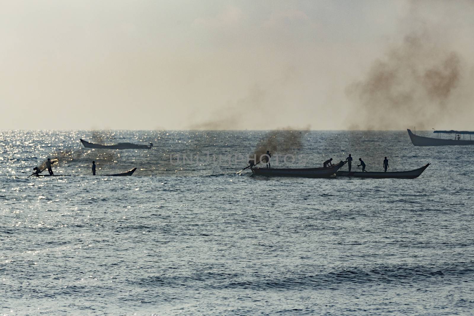 Pondichery, Tamil Nadu, India - February 27, 2014 : Traditional fishermen on beach, on sea, on sand. Long boats, Hard work poor people