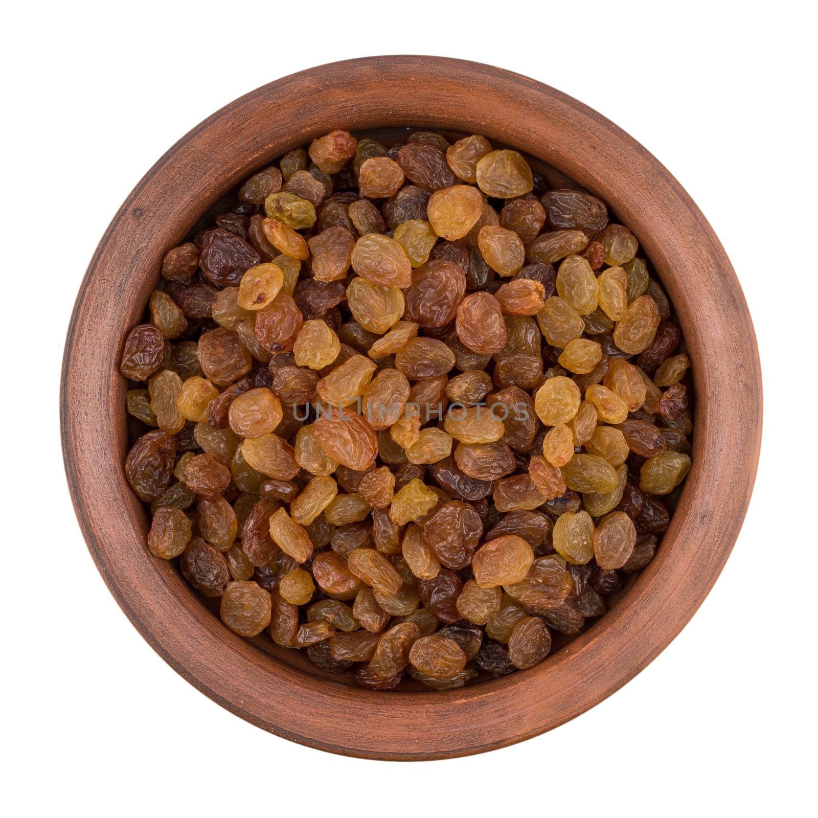 Brown ceramic bowl with raisins isolated on white background. Top view.