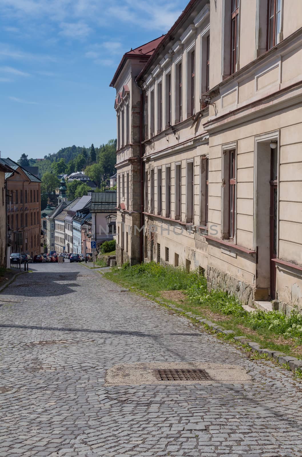 Street in Banska Stiavnica, former mining city, which is in the UNESCO World Heritage list. Calm summer morning.