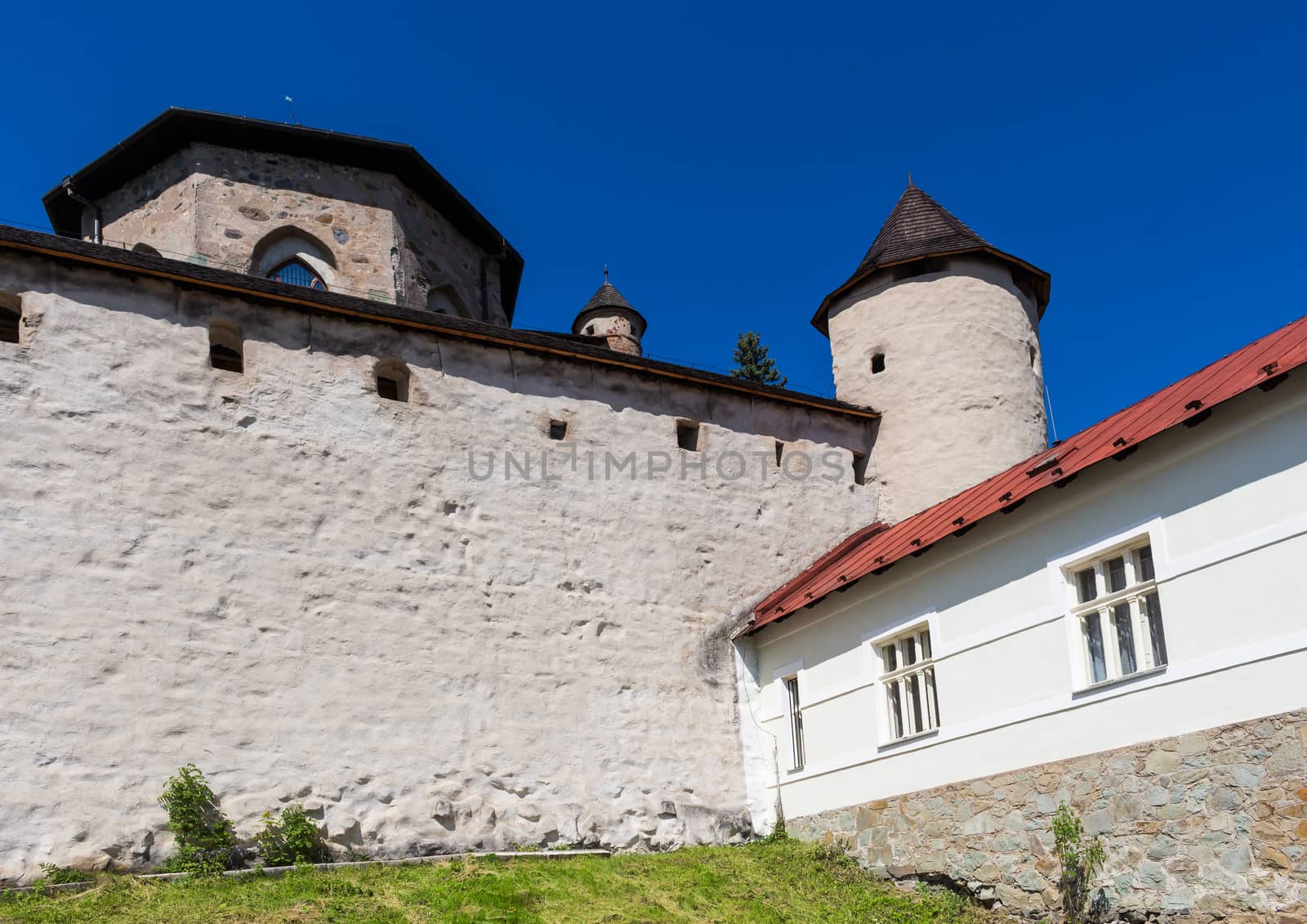 Part of a fortification of the Old Castle in the city Banska Stiavnica, Slovakia. Summer blue sky.