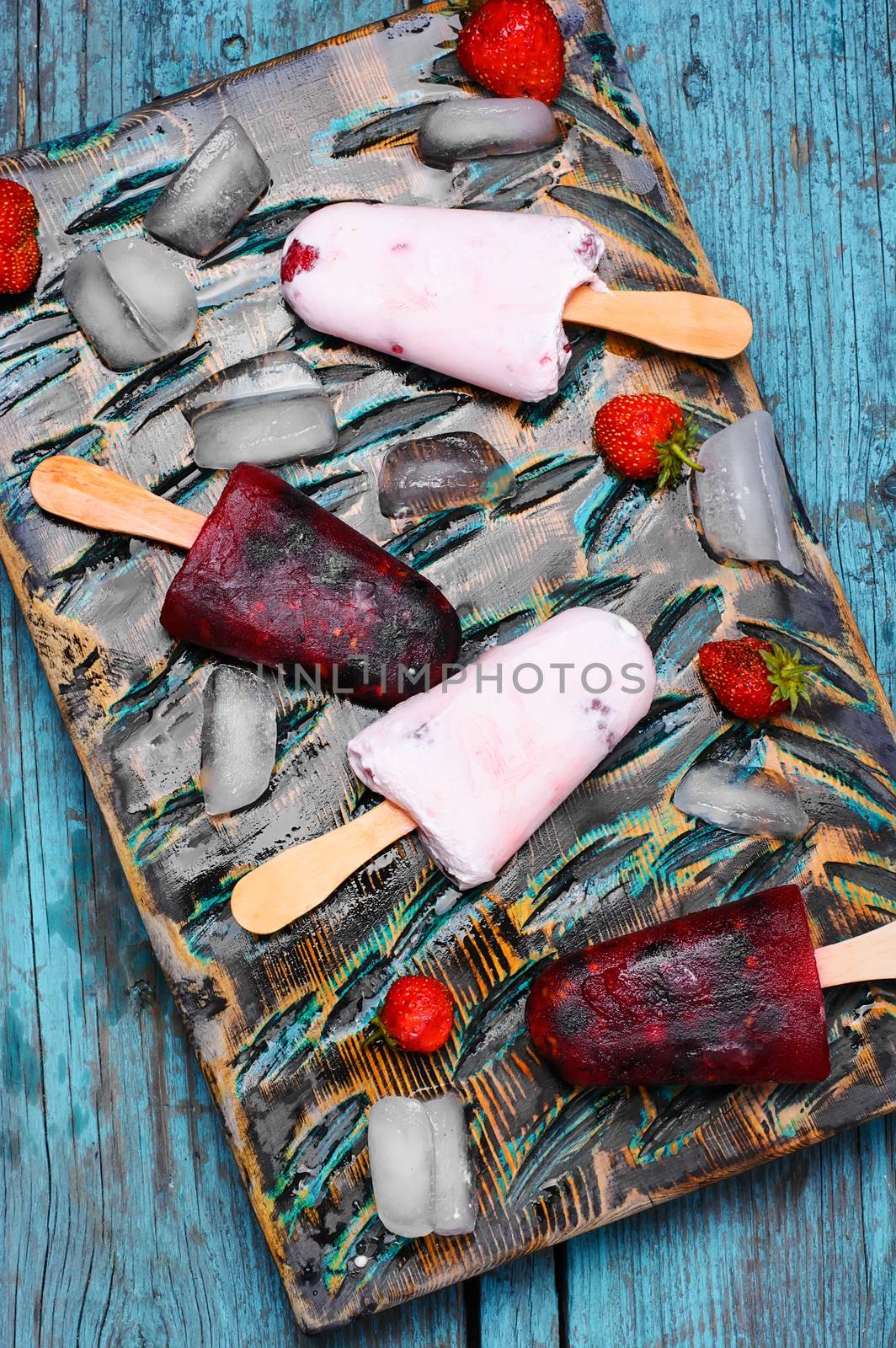 Ice cream on the kitchen chalkboard and berries fresh strawberries