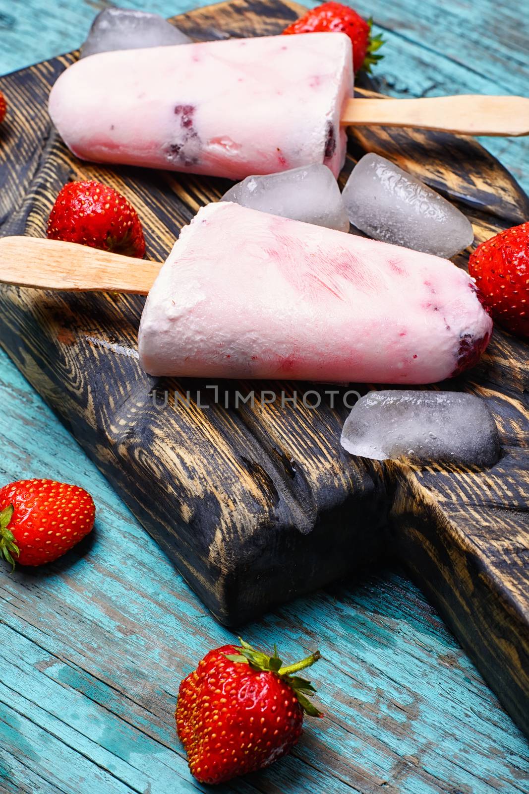 Ice cream on the kitchen chalkboard and berries fresh strawberries