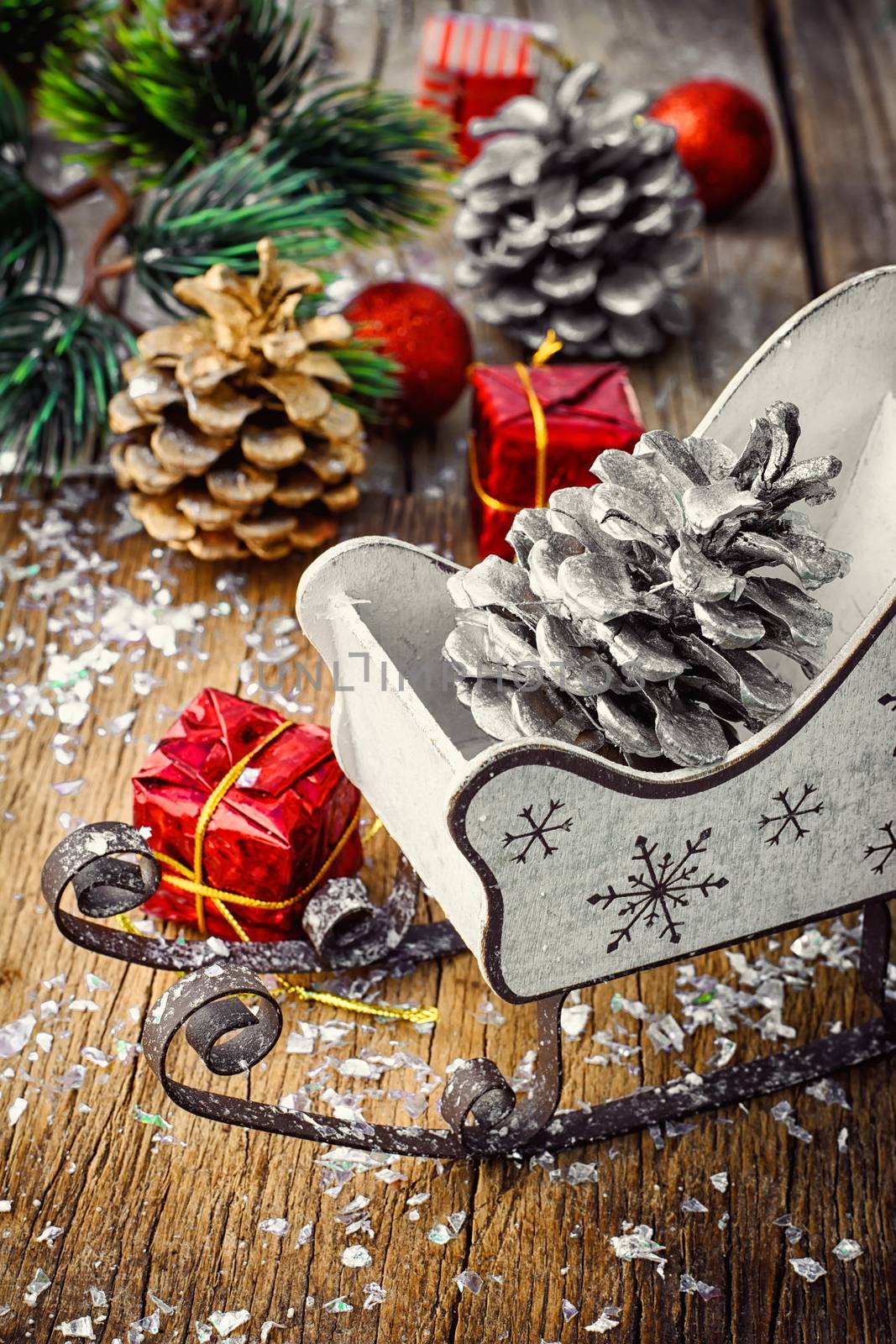 Christmas tree with pine cones,decorative sleigh, and decorations