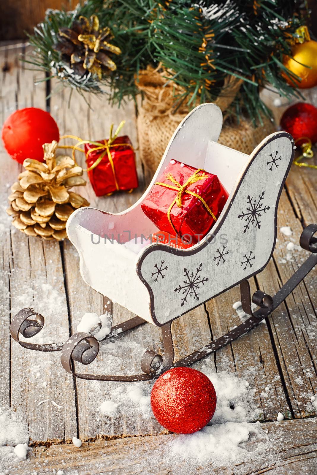 Christmas tree with pine cones,decorative sleigh, and decorations