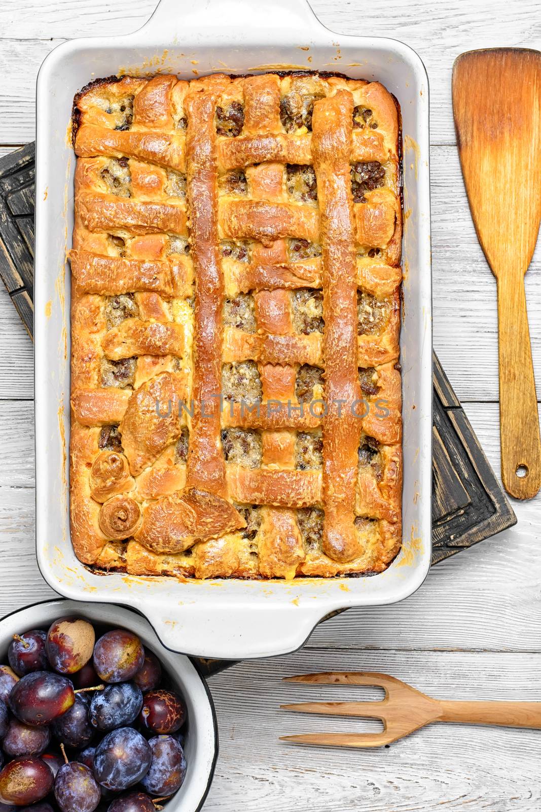 Baked according to traditional recipe meat pie with plums