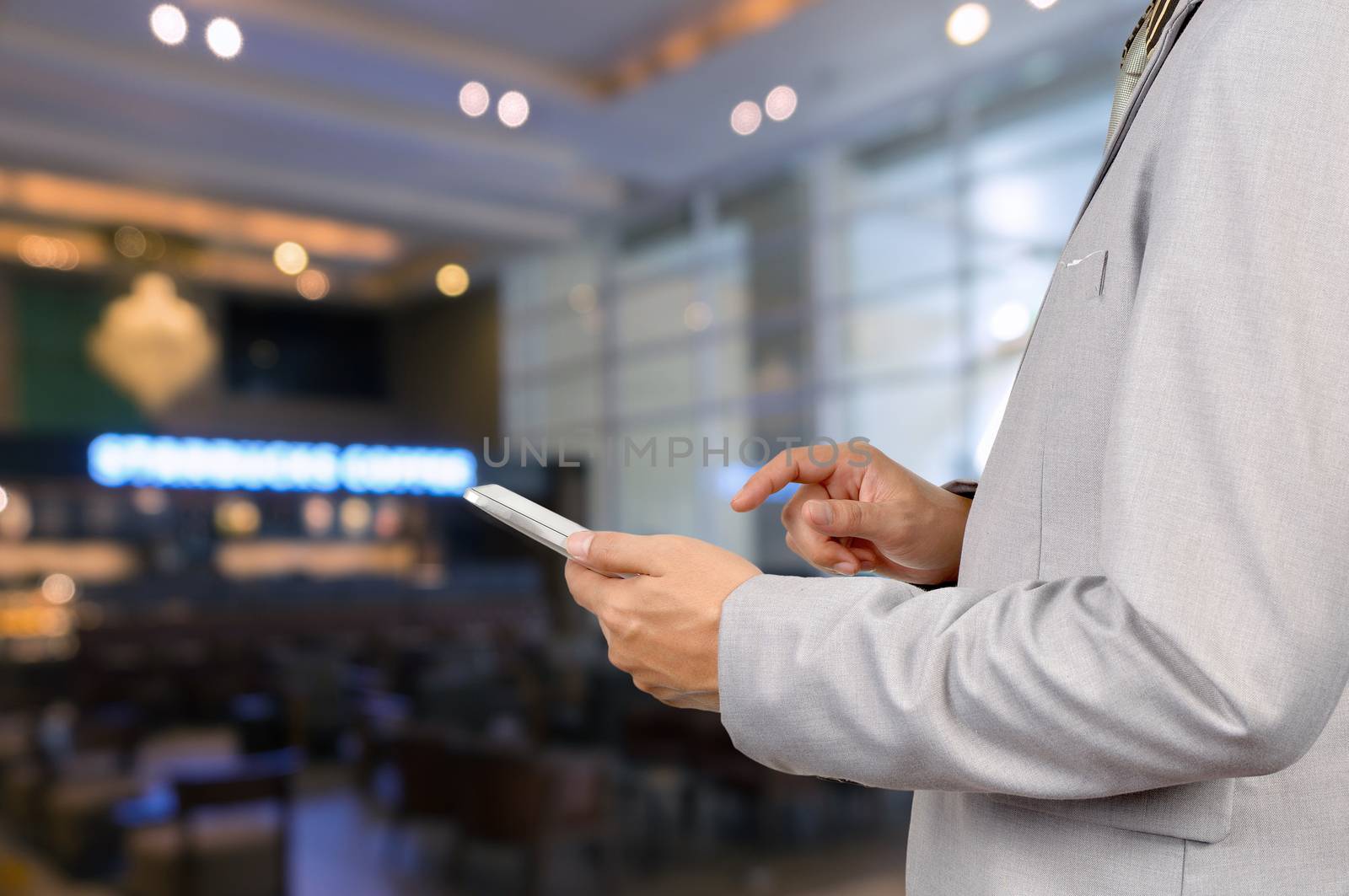 Businessman Use Wireless Tablet Device in Restaurant with Bokeh, Close up shot.