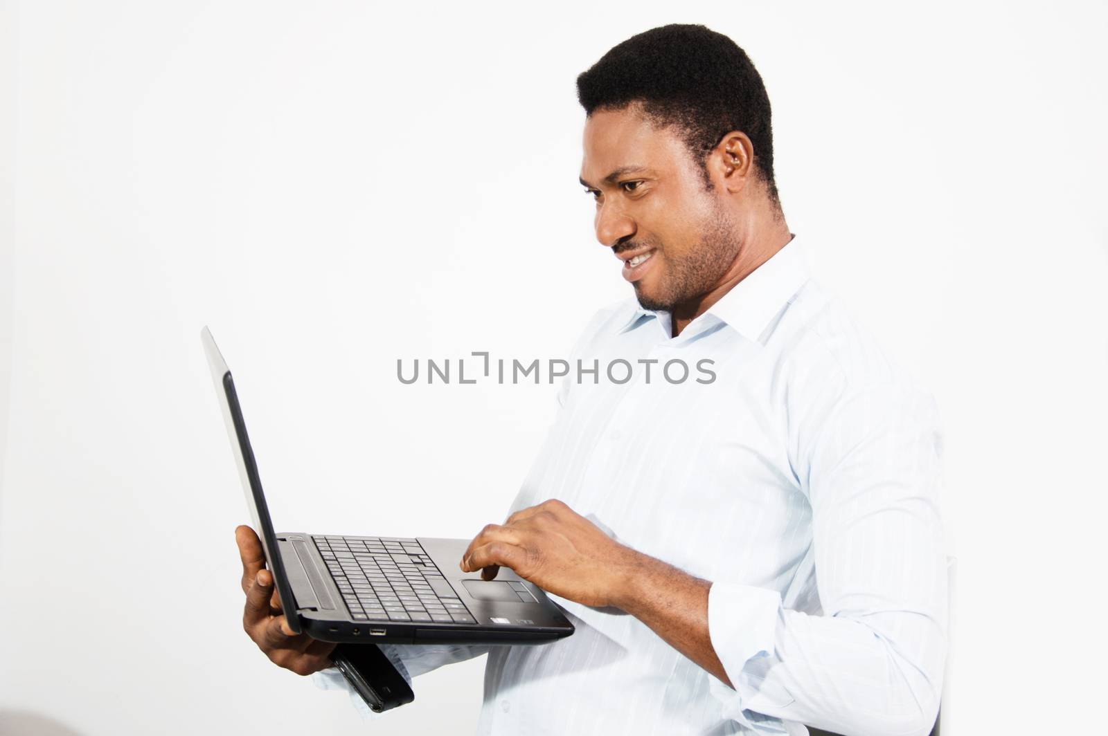 This young man feels more confortable working standing with his laptop in hand.