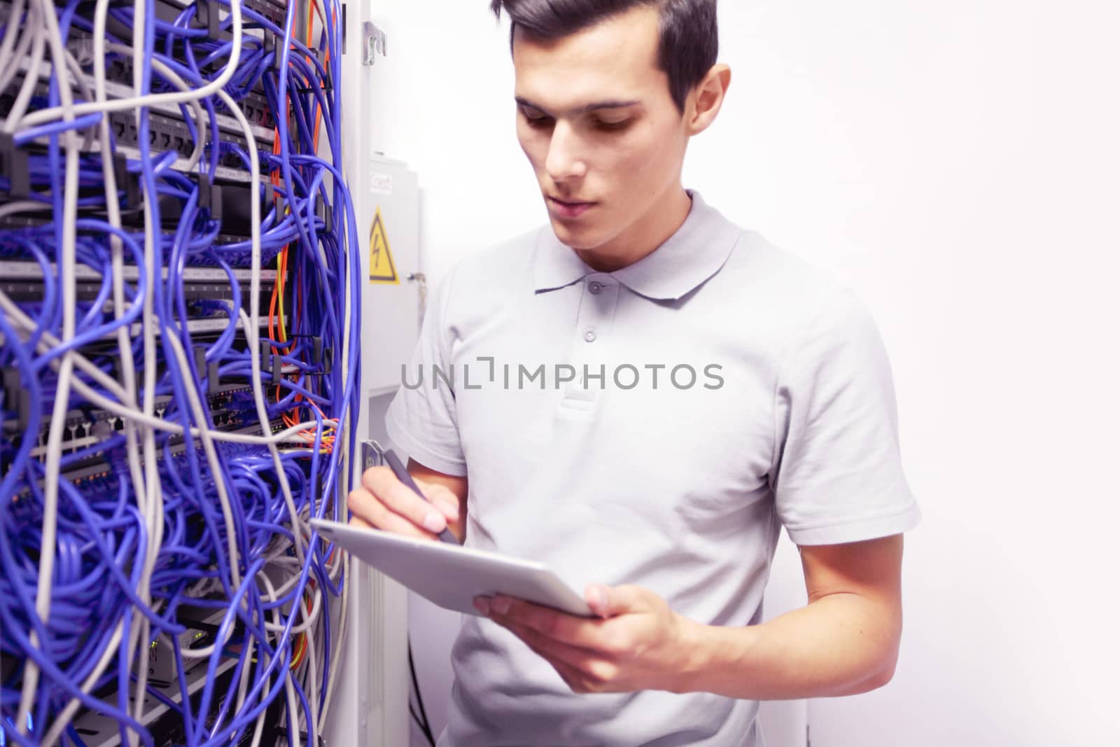 Man in network server room by ALotOfPeople