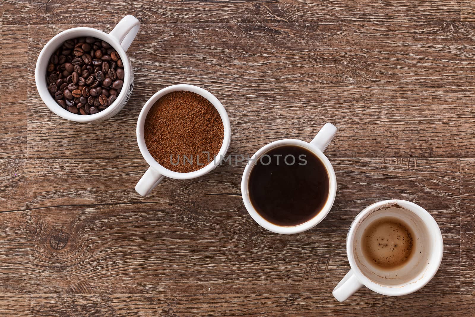 Four cups of coffee, phases of drink - bean, ground and empty cup