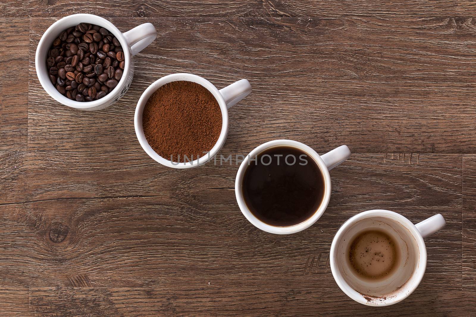 Four cups of coffee, phases of drink - bean, ground and empty cup