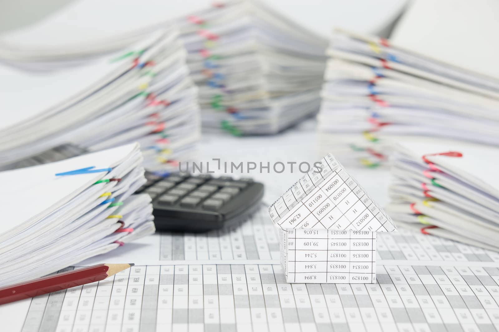 House and brown pencil with blur pile paperwork as background by eaglesky