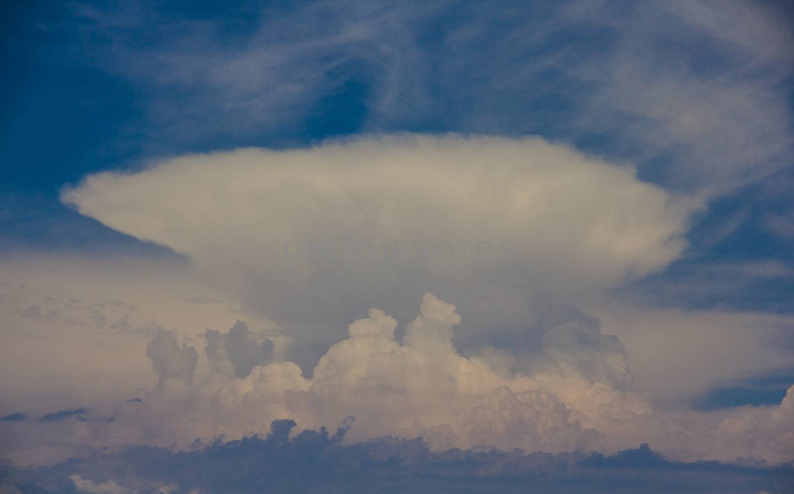 Mushroom clouds in the dark blue sky