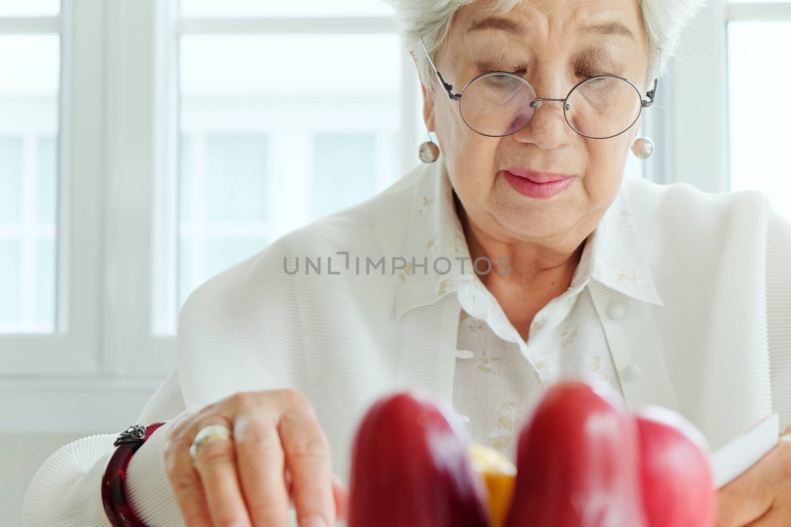 Senior woman reading a book at home