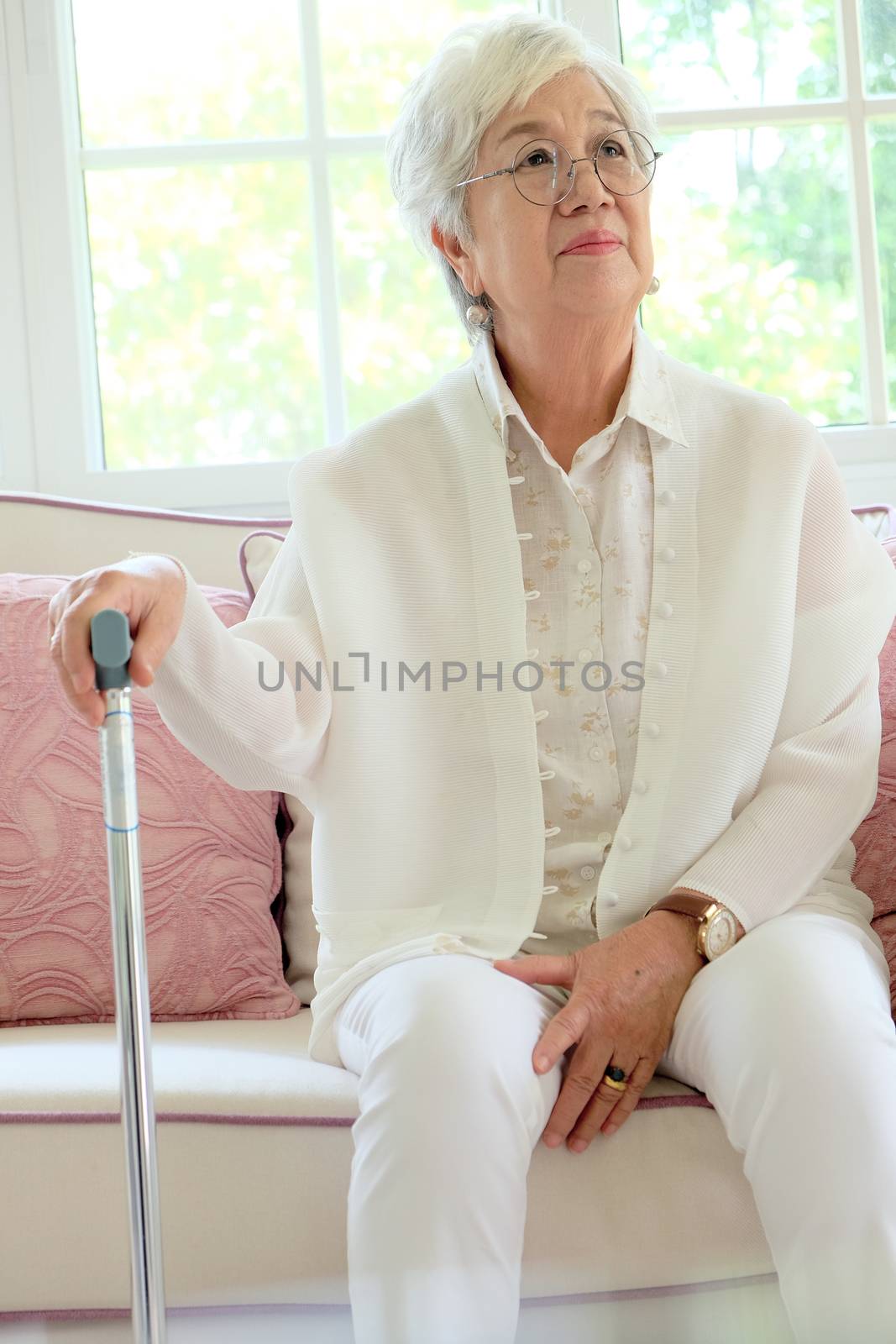 Retired woman with her walking stick