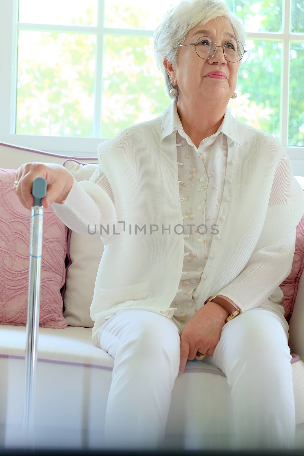 Retired woman with her walking stick