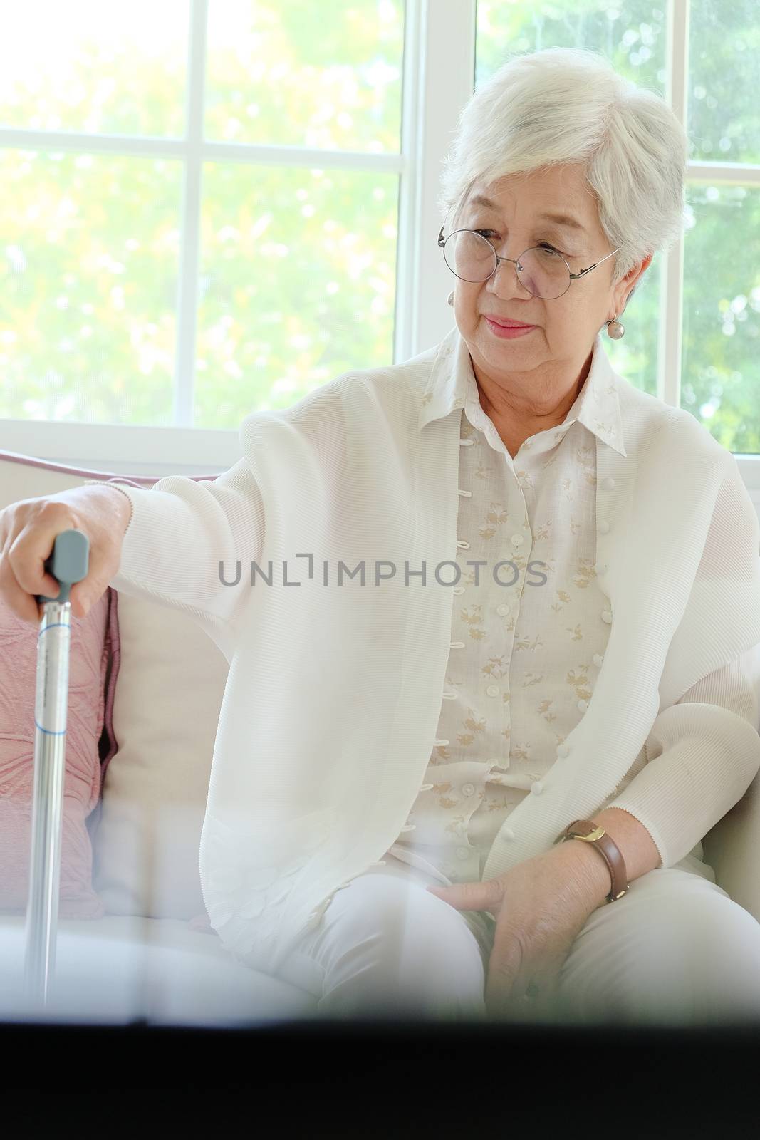 Retired woman with her walking stick