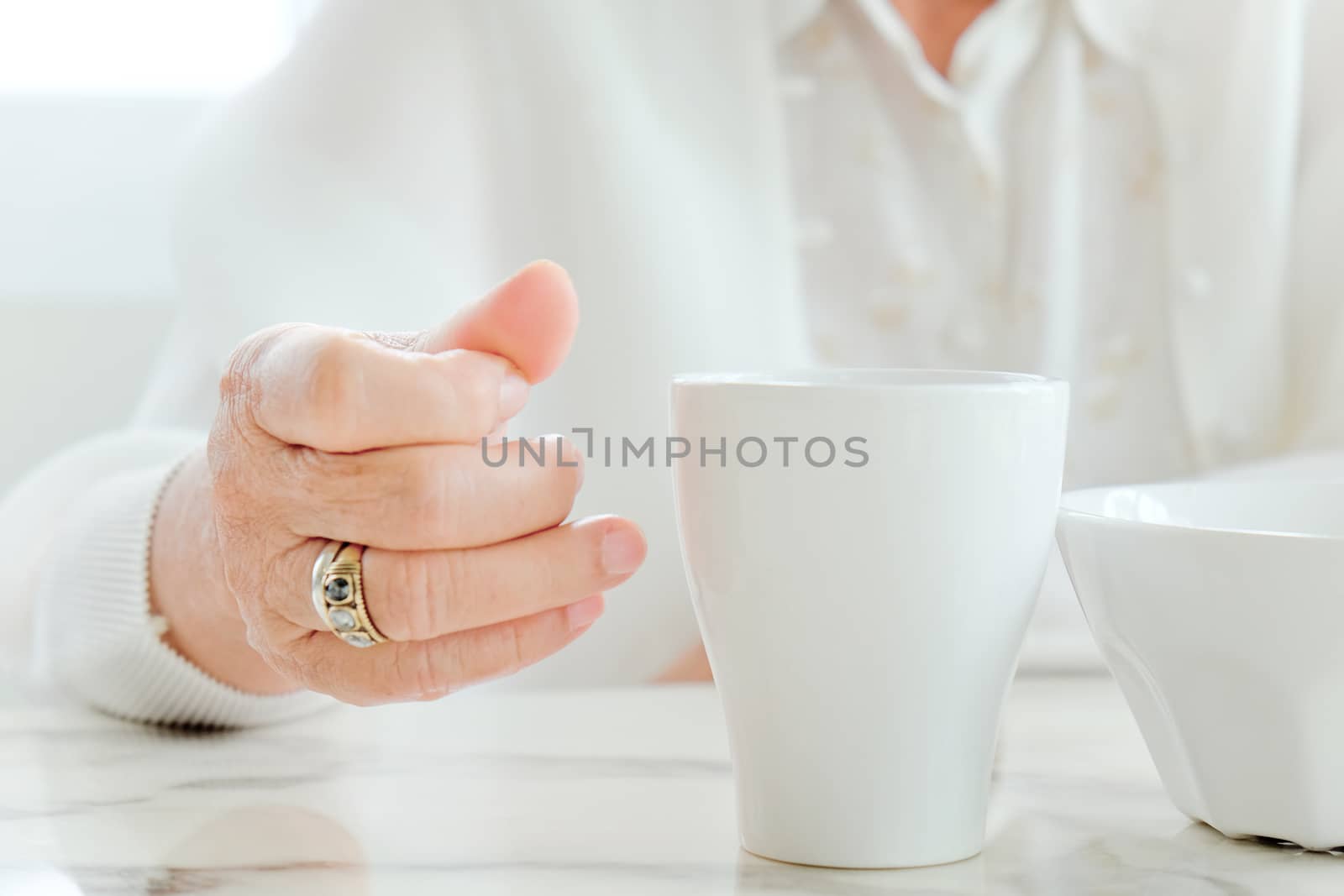 Close up image of senior women with drink, meal time