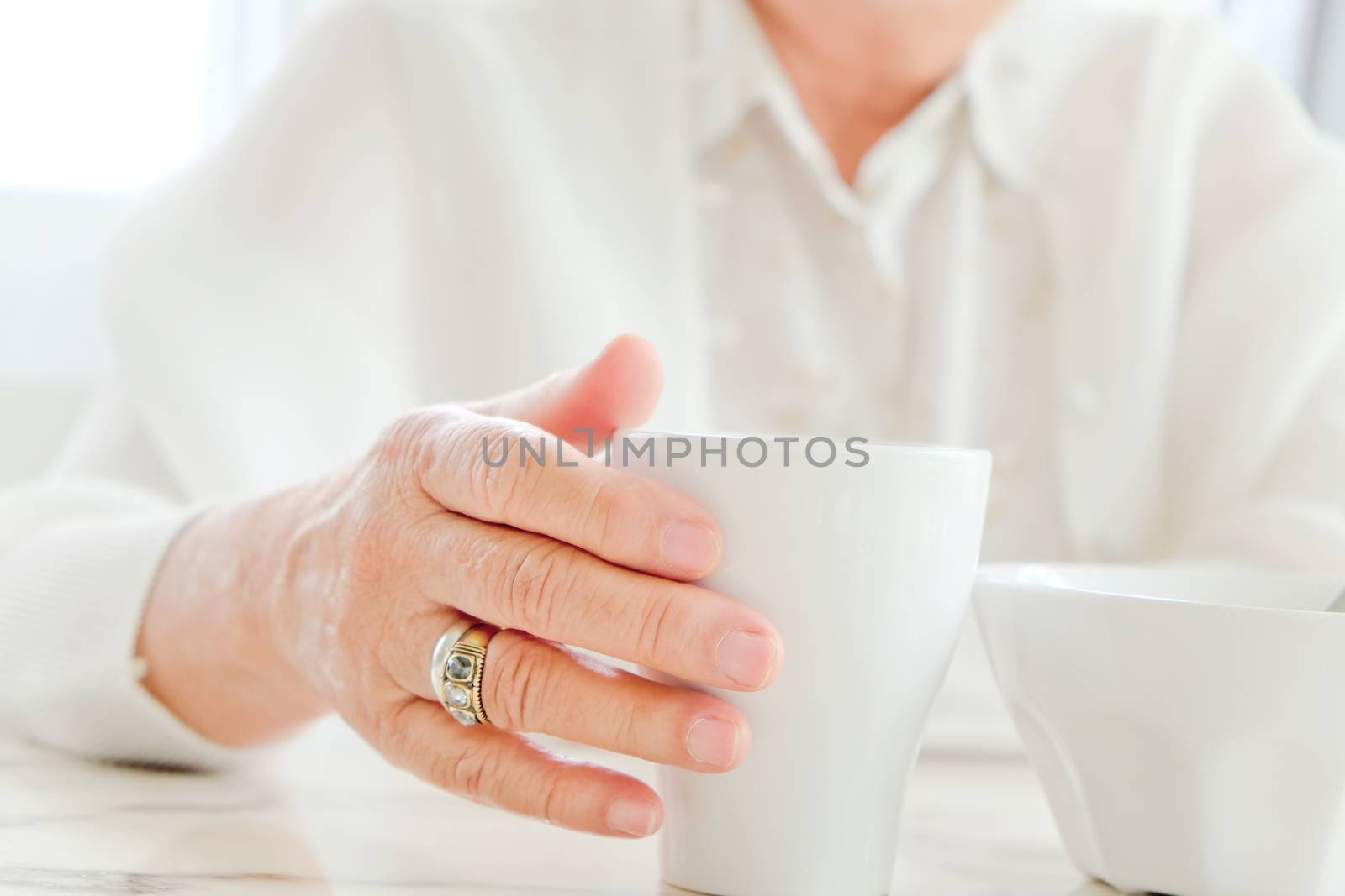 Close up image of senior women with drink, meal time