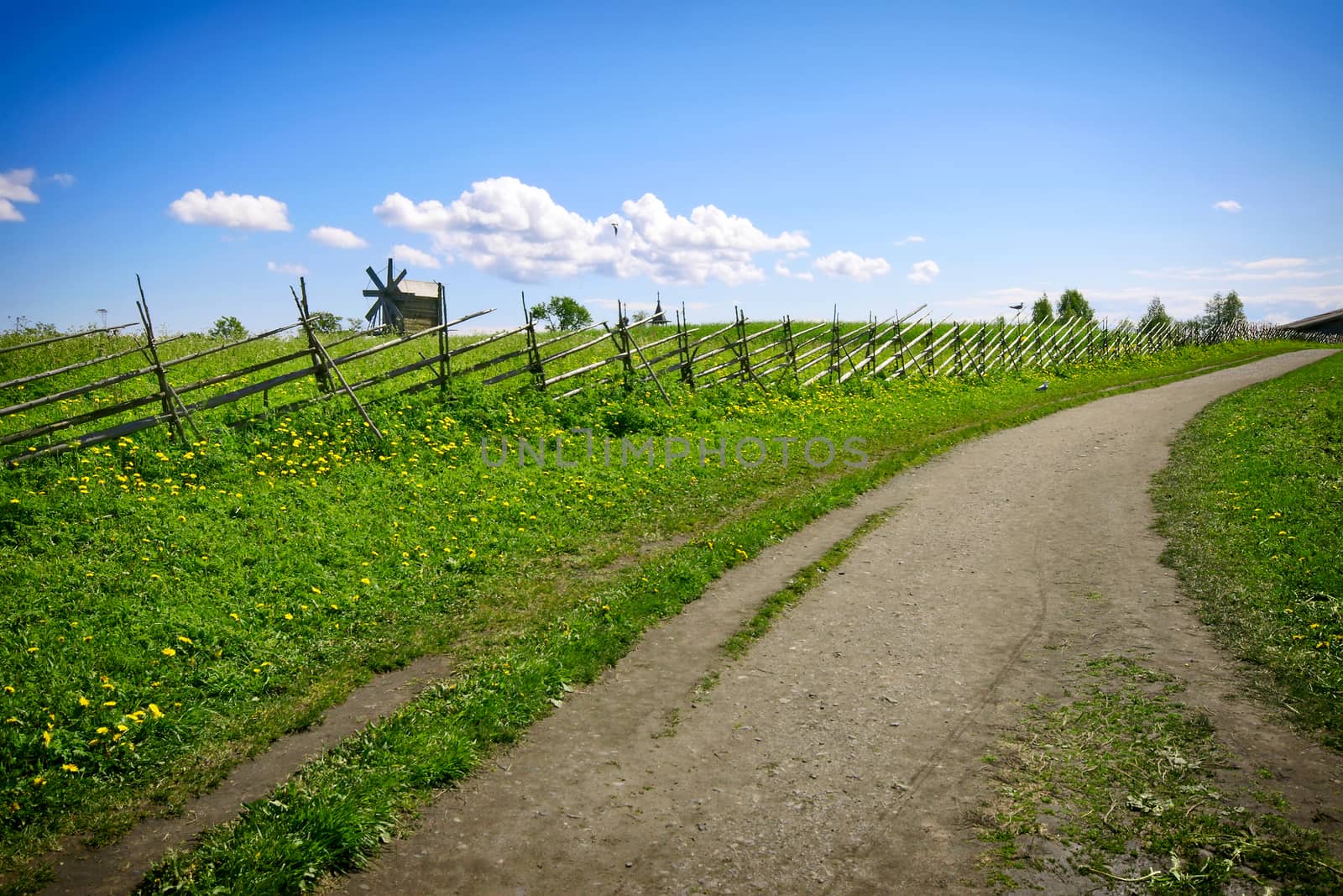 Green lanscape with one old windmill and blue sky, Russia