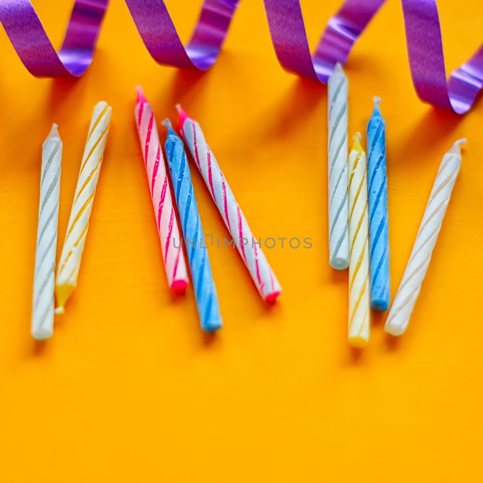 Candles and streamer on a yellow background