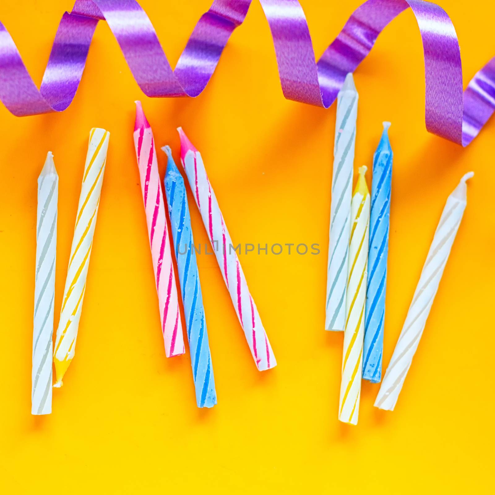 Candles and streamer on a yellow background