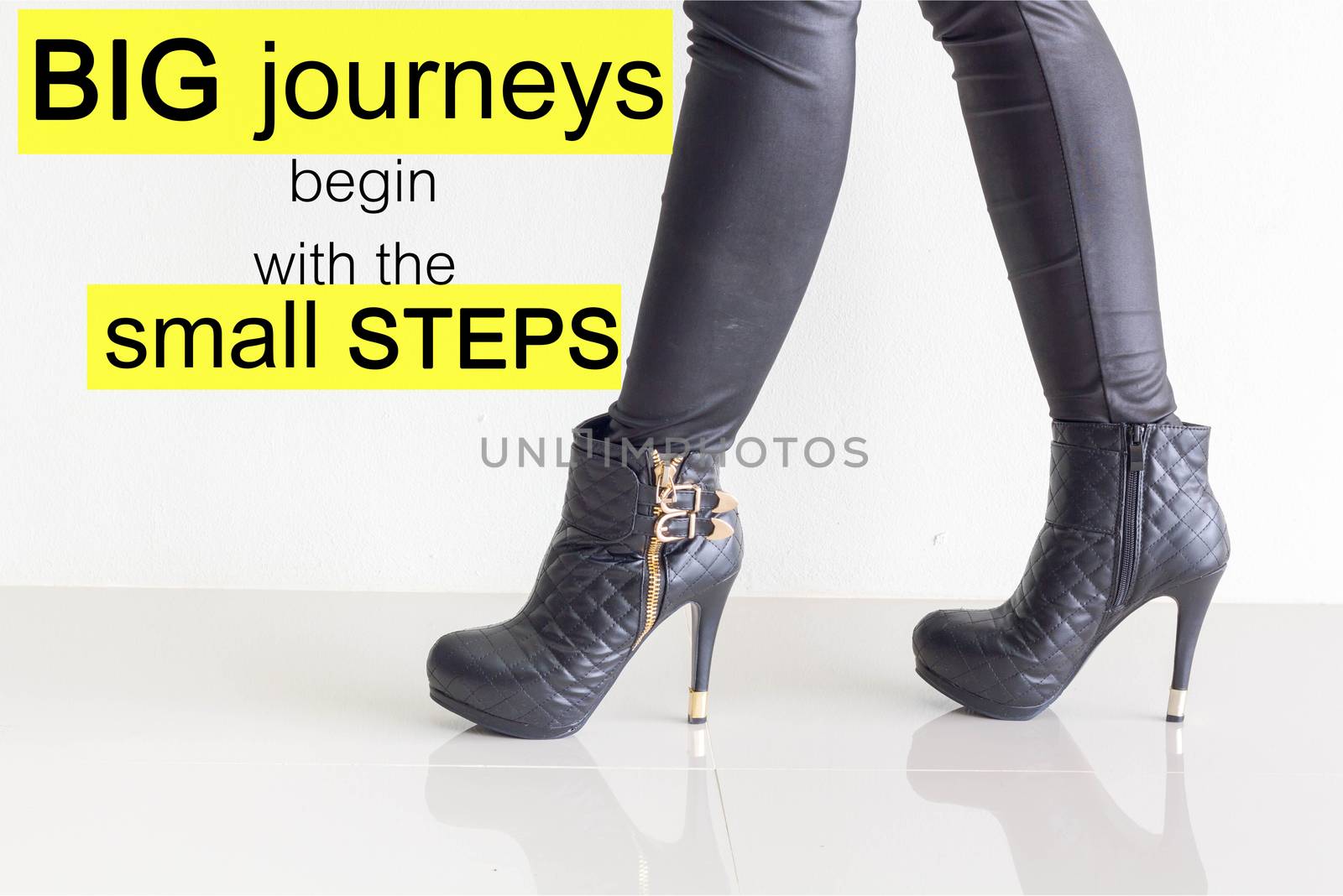 Word  Big journeys begin with the small steps.Inspirational motivational quote on black leather pants and high heel shoes background