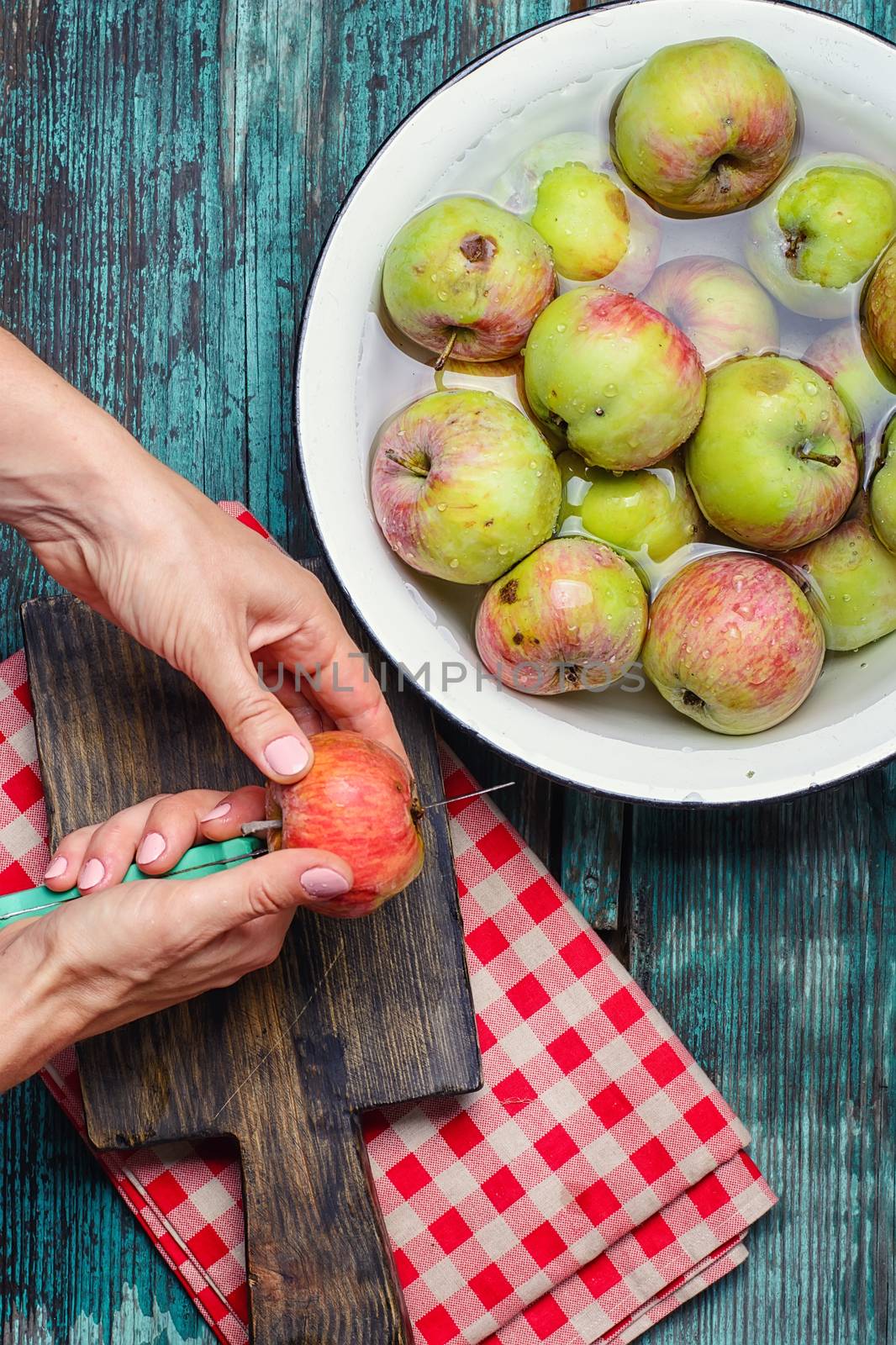 Man washes and cleans the autumn apple harvest