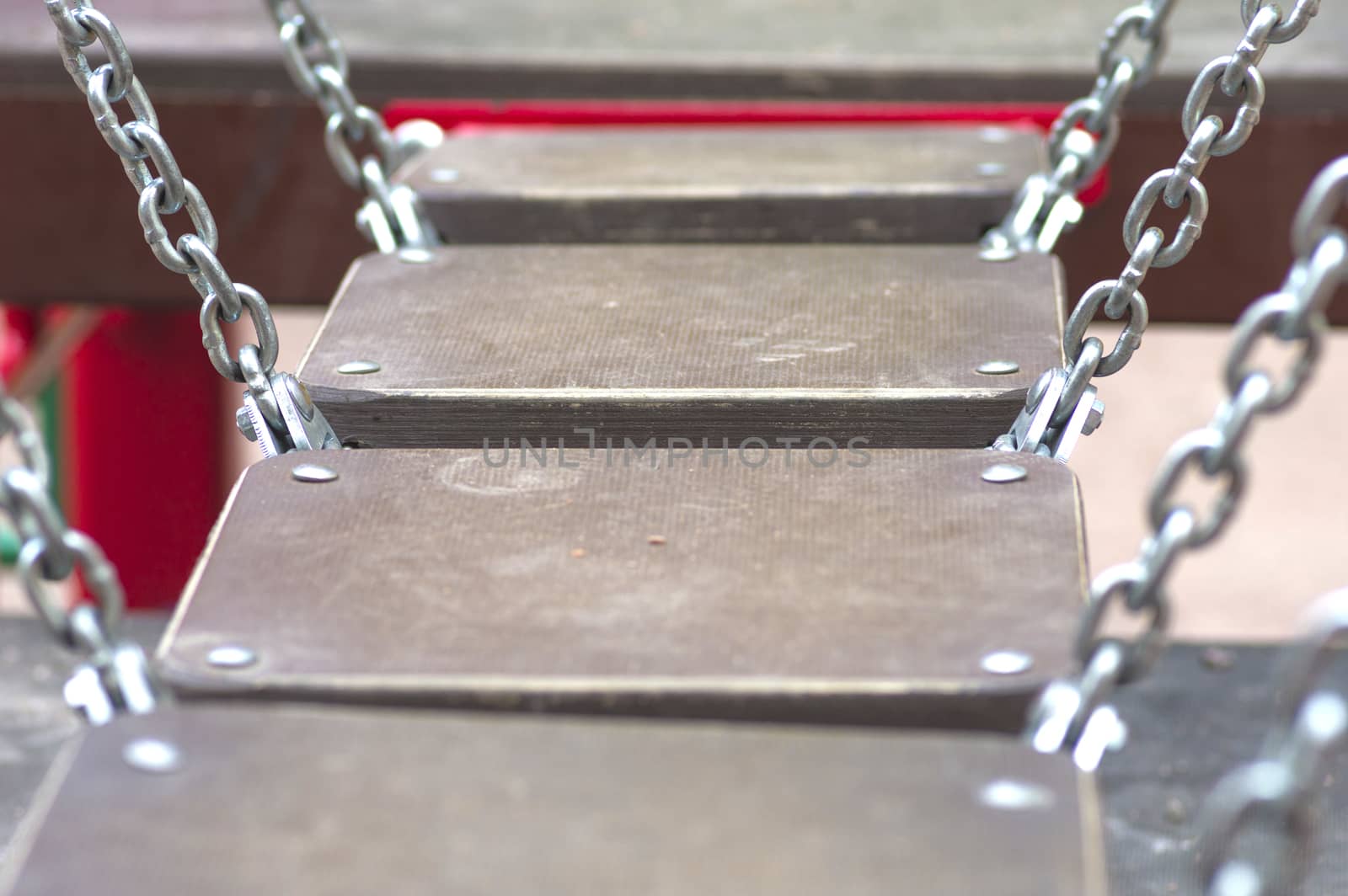 bridge on the chains of the wooden planks on the playground