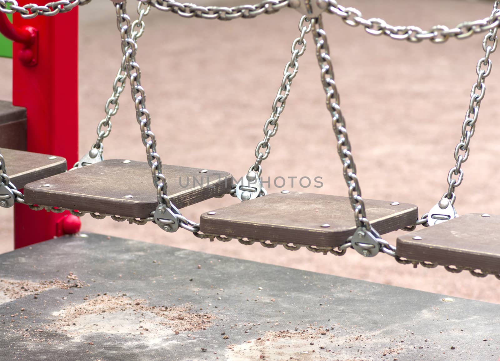 bridge on the chains of the wooden planks on the playground