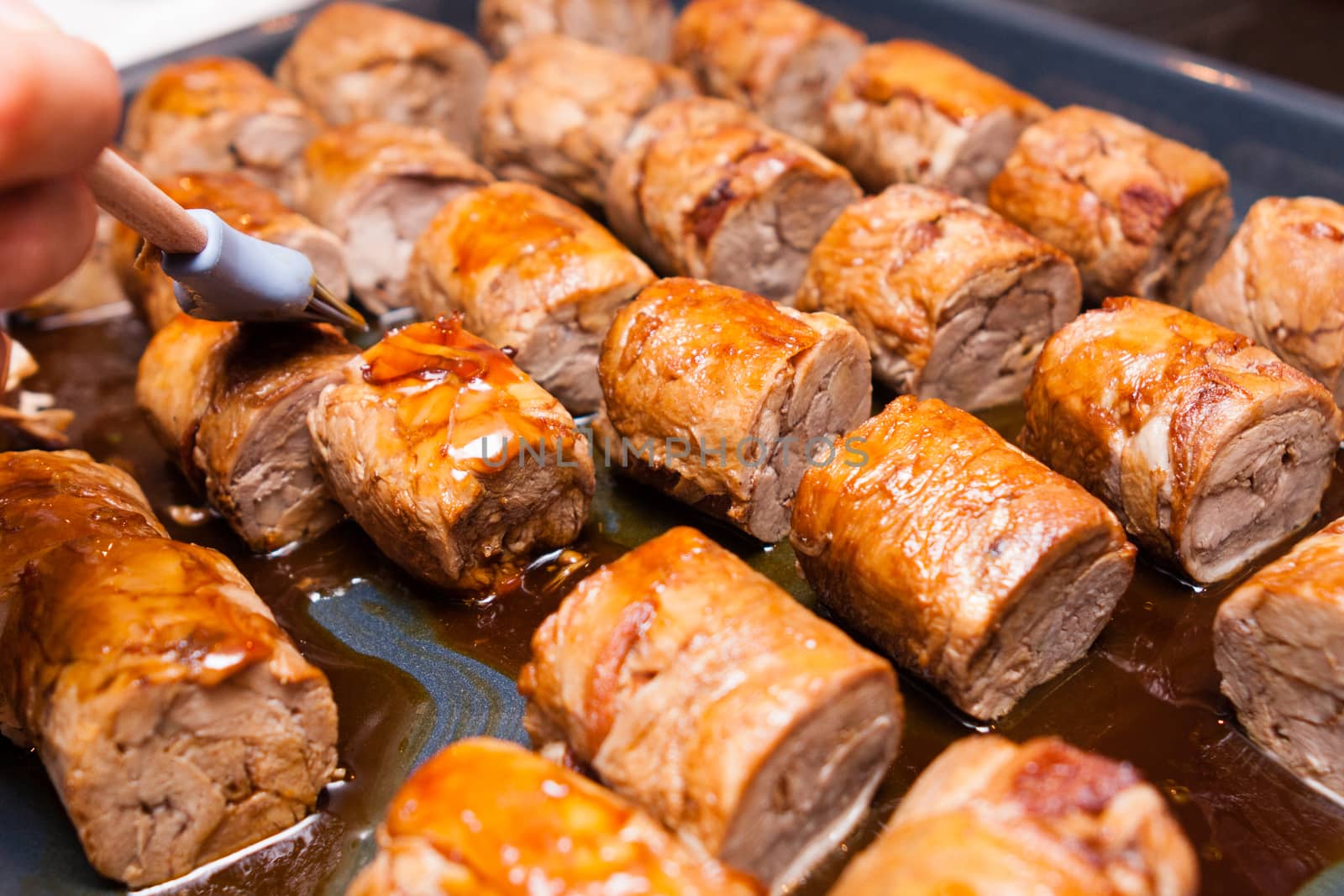 meat rolls on metallic platter in oven