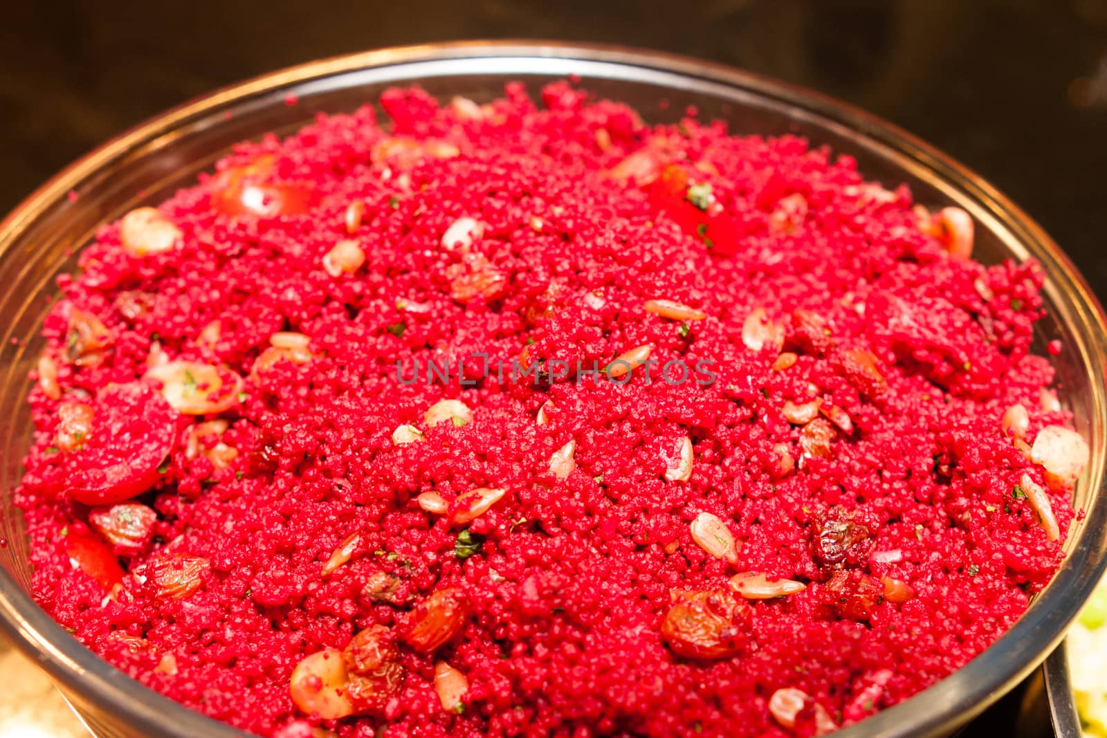bowl of cous cous painted red with vegetables