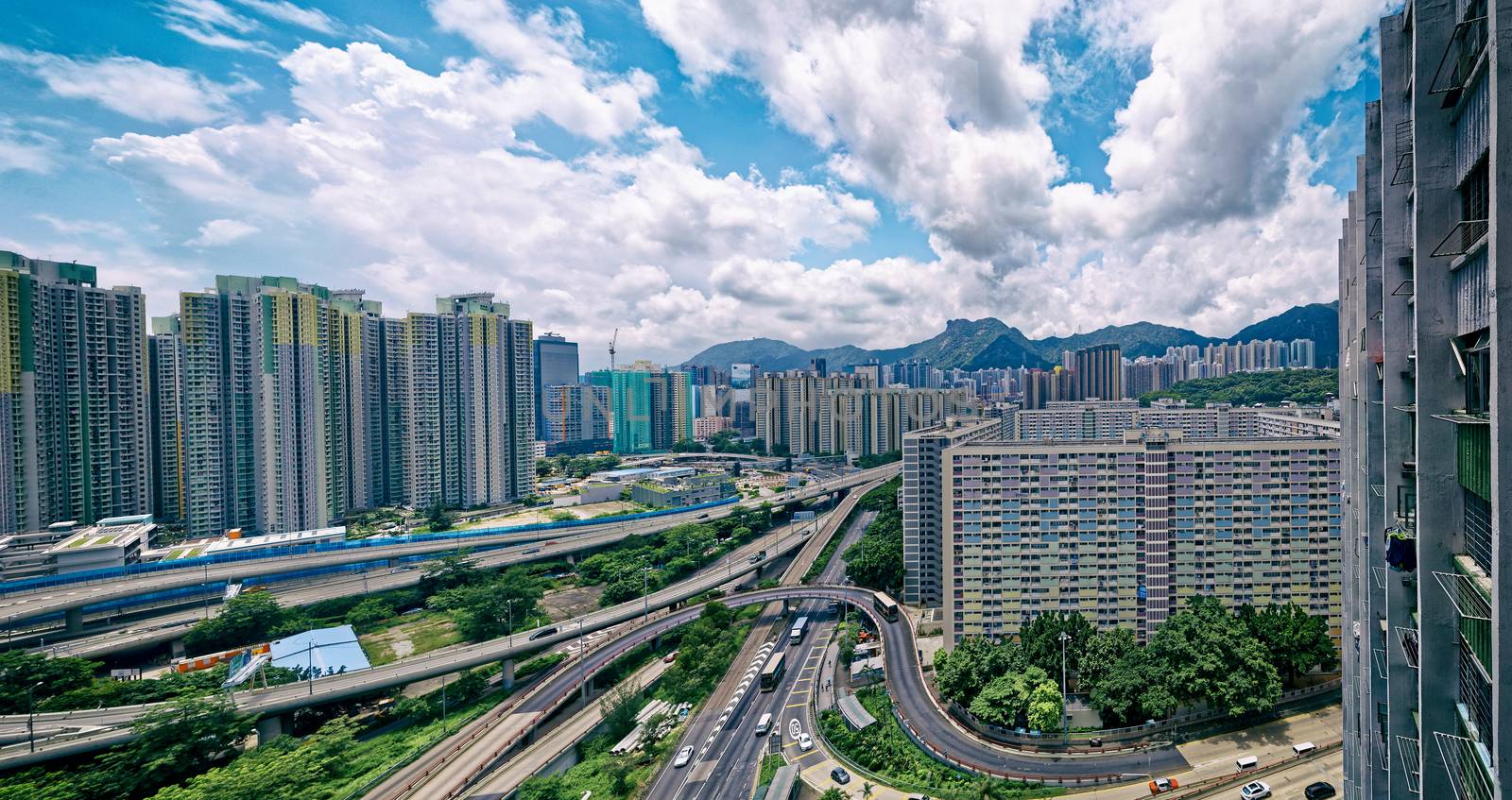 hong kong public estate buildings with landmark lion rock at day