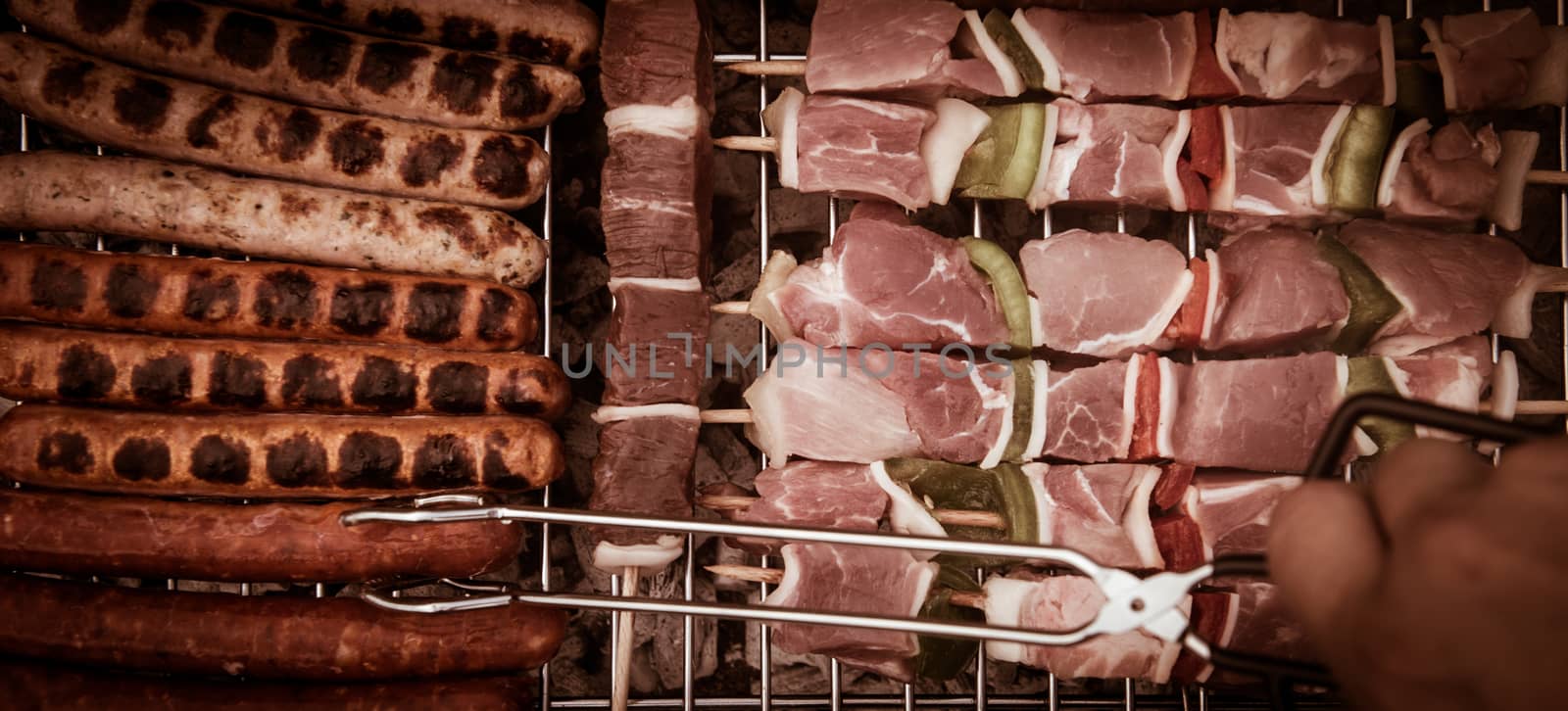 Barbecue with delicious grilled meat on grill. Meat brochettes on grill fire.