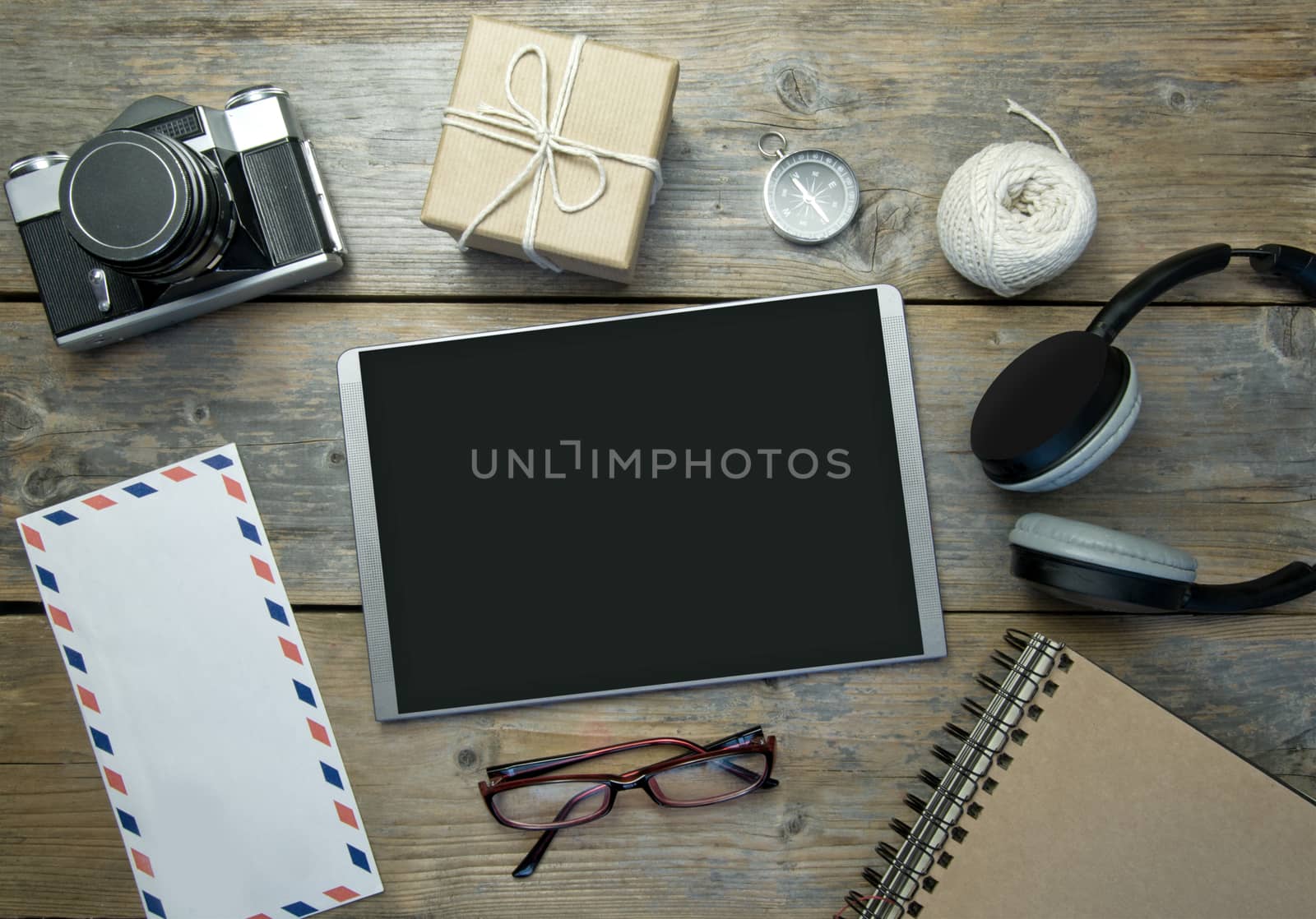 Blank digital tablet with stationery objects, compass and camera 