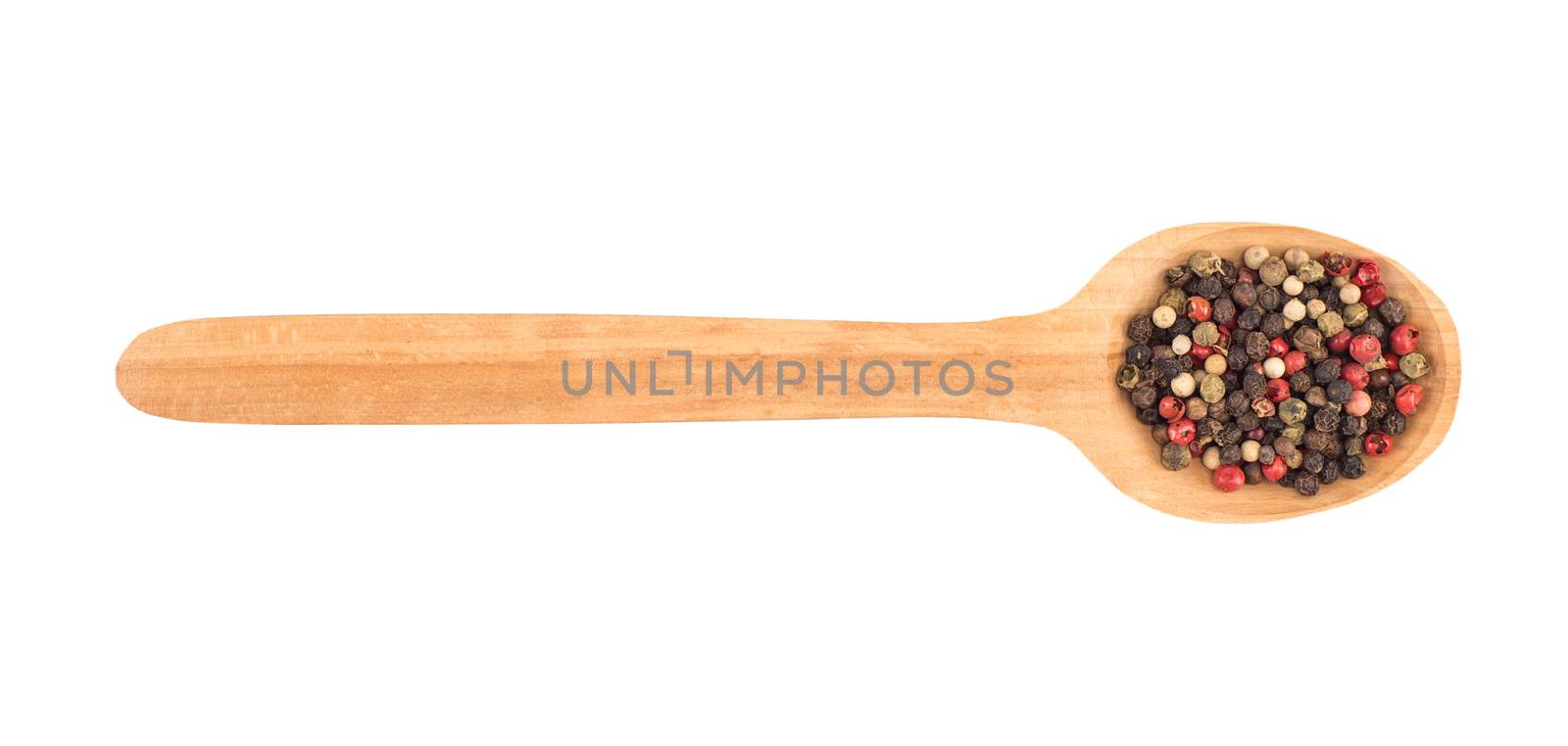 Colored pepper on a wooden spoon isolated on white