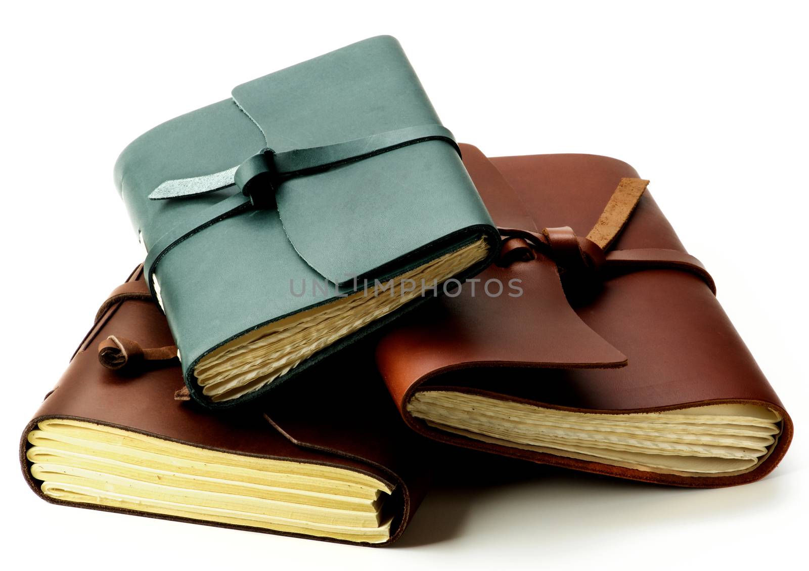 Heap of Various Luxury Handmade Leather Notepads with Craft Paper closeup on White background