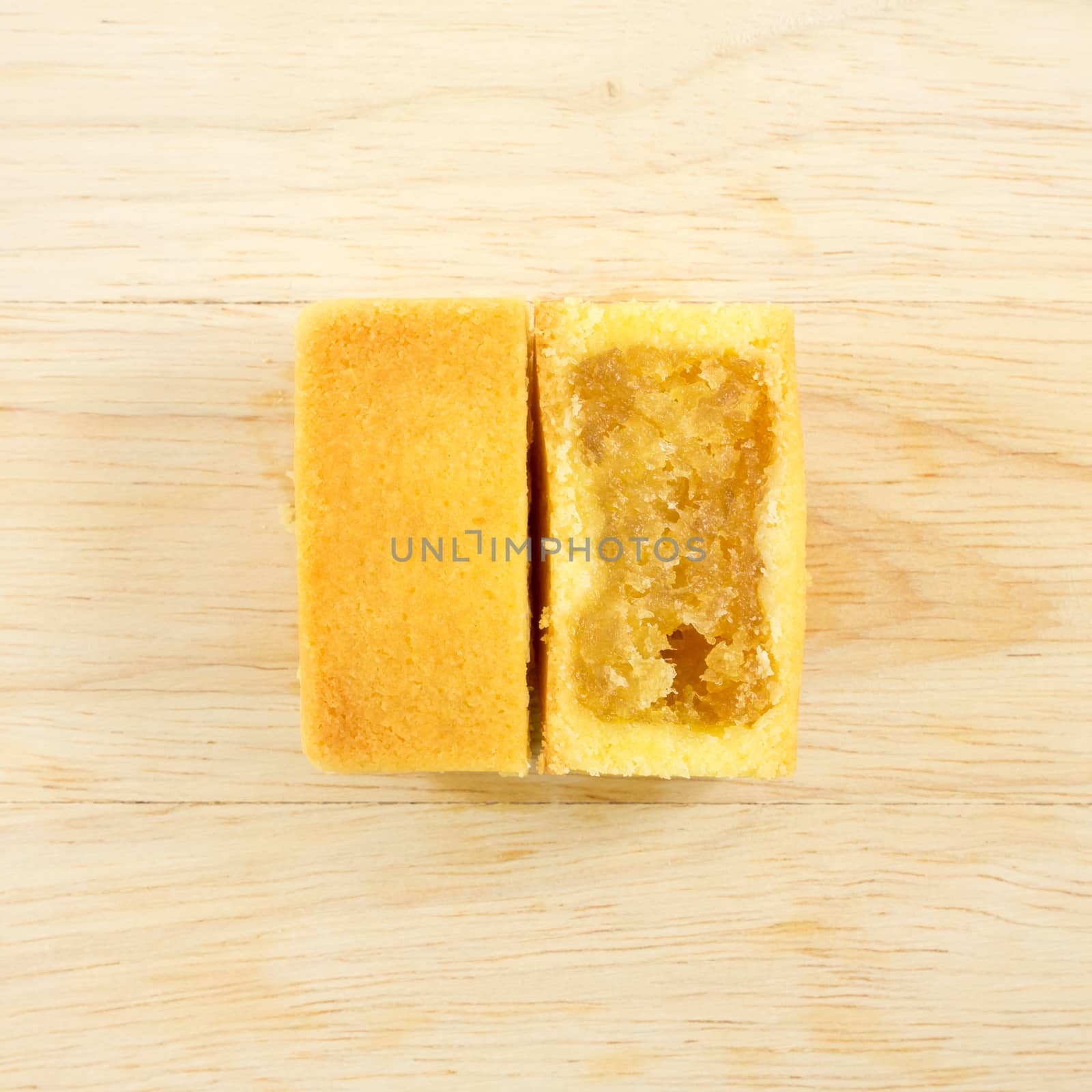 The tasty Taiwanese pineapple pastry cake with egg yolk on the wooden plank.