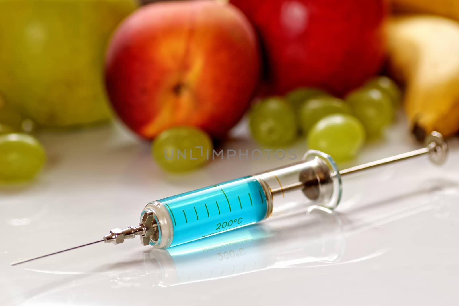 fresh fruits versus modern medicine, injection with blue fluid