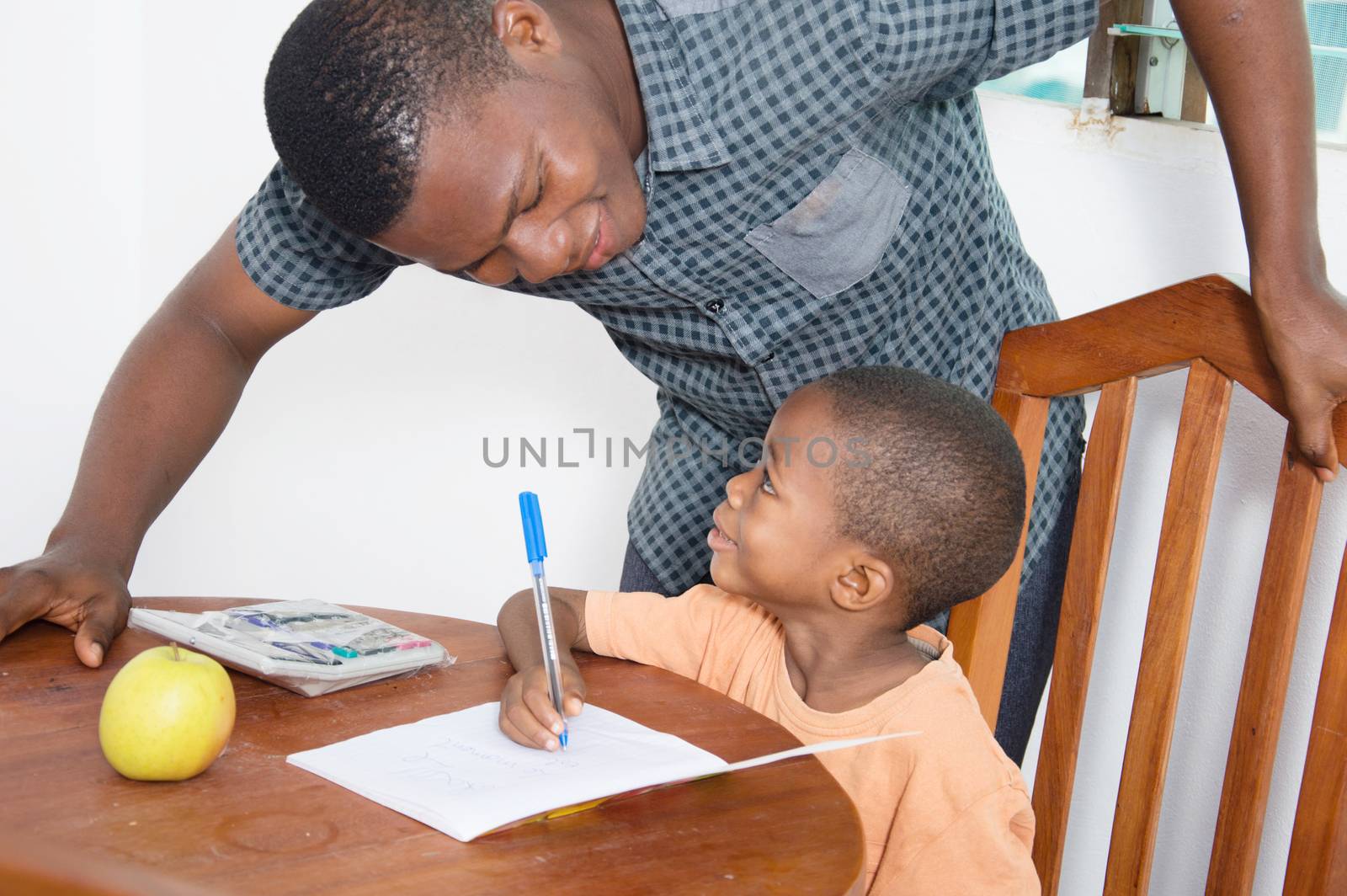 The teacher explains something to the schoolboy looking at his face.