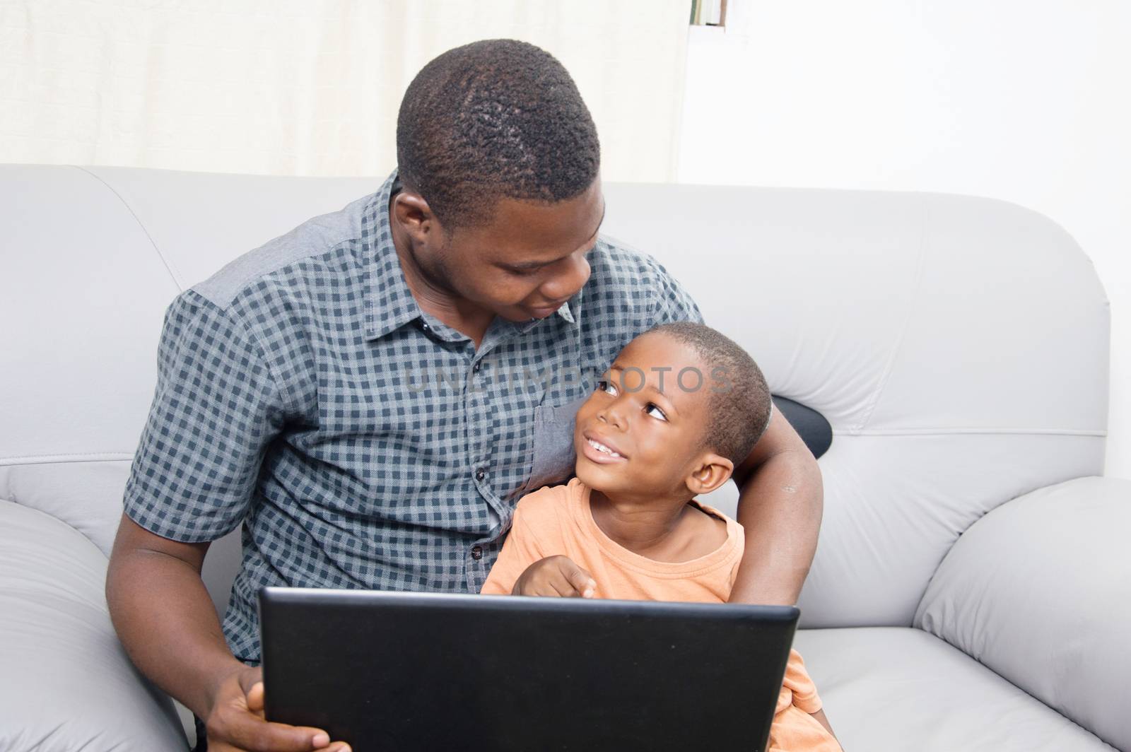 The father is happy to see his child to know and work with a laptop.