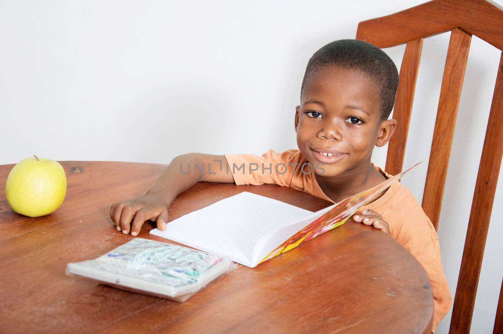 This child is very happy to study evening at home.