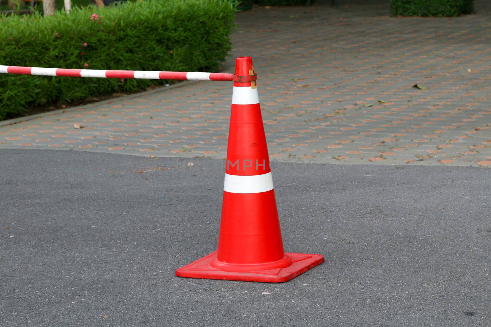 traffic cone, with white and orange stripes on gray asphalt, by N_u_T