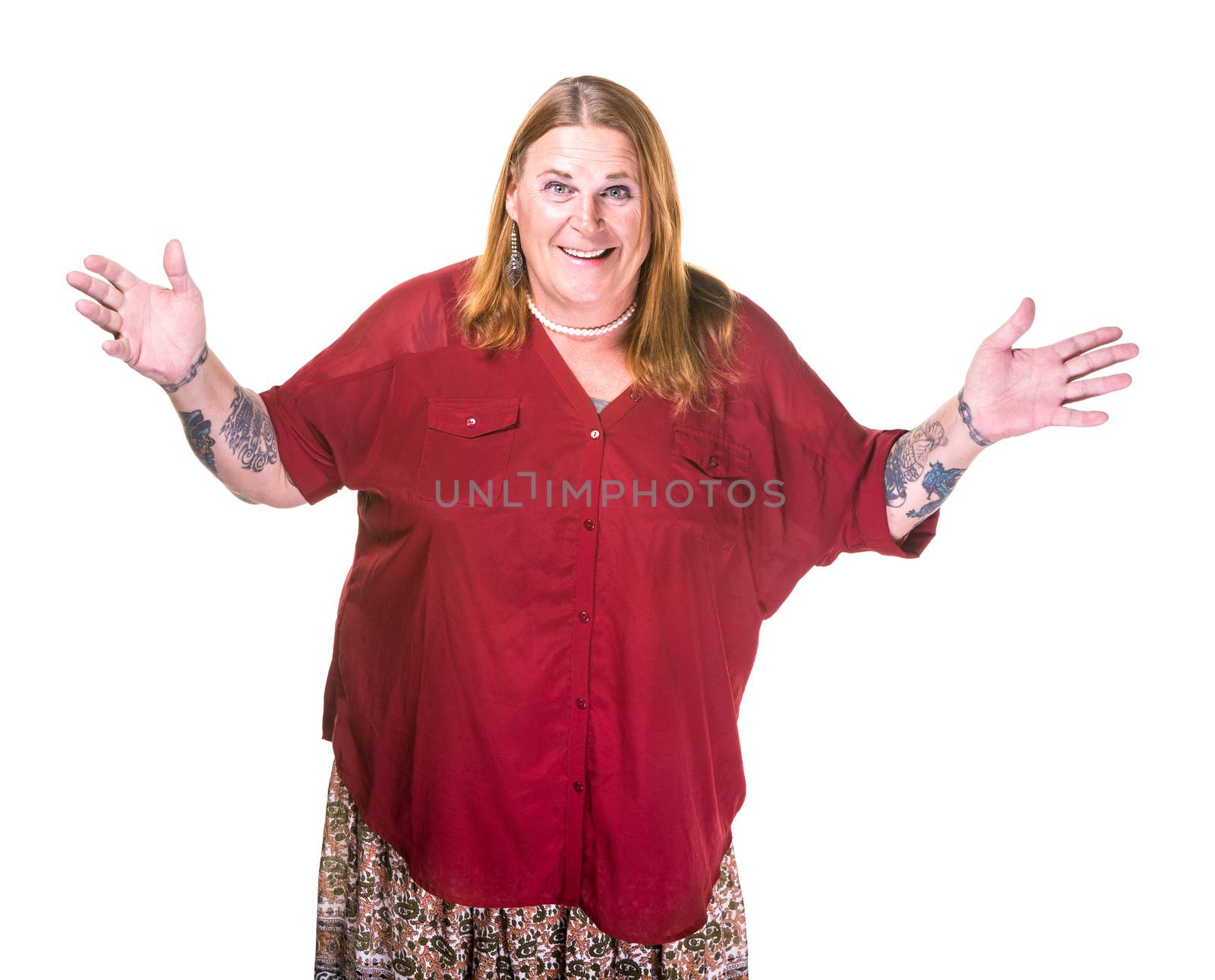 Transgender woman in pearl necklace on white background gesturing with hands out wide