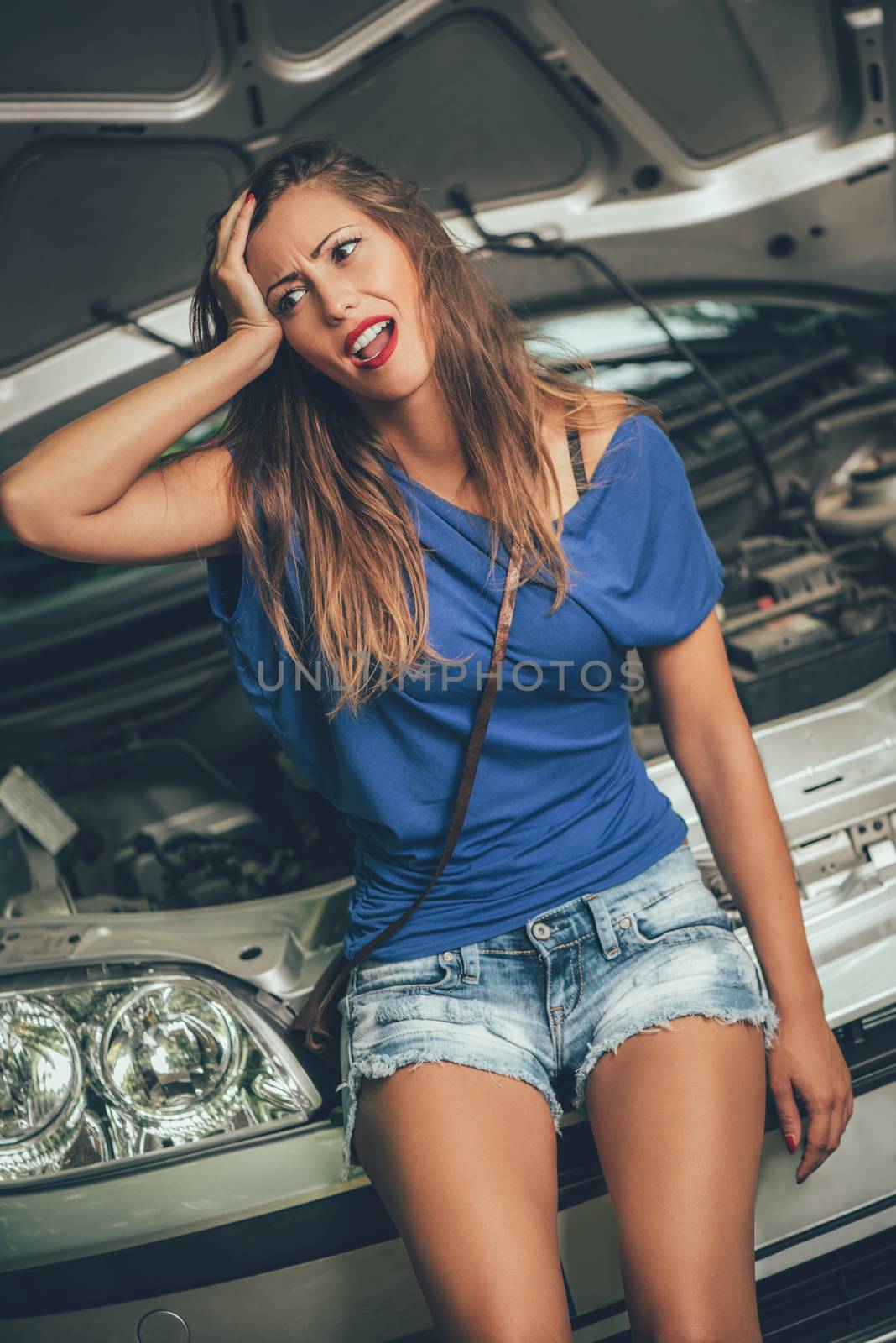 Beautiful girl is desperate when realizing that her car broke down. 