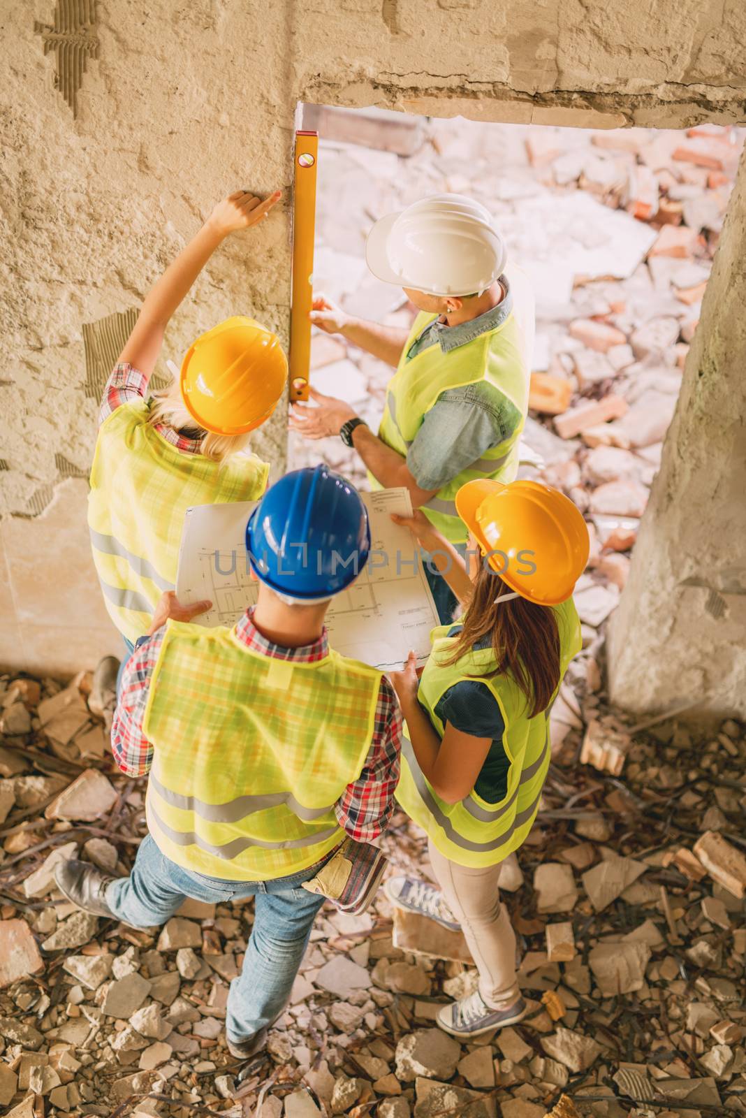 Four construction architects review building damaged in the disaster.