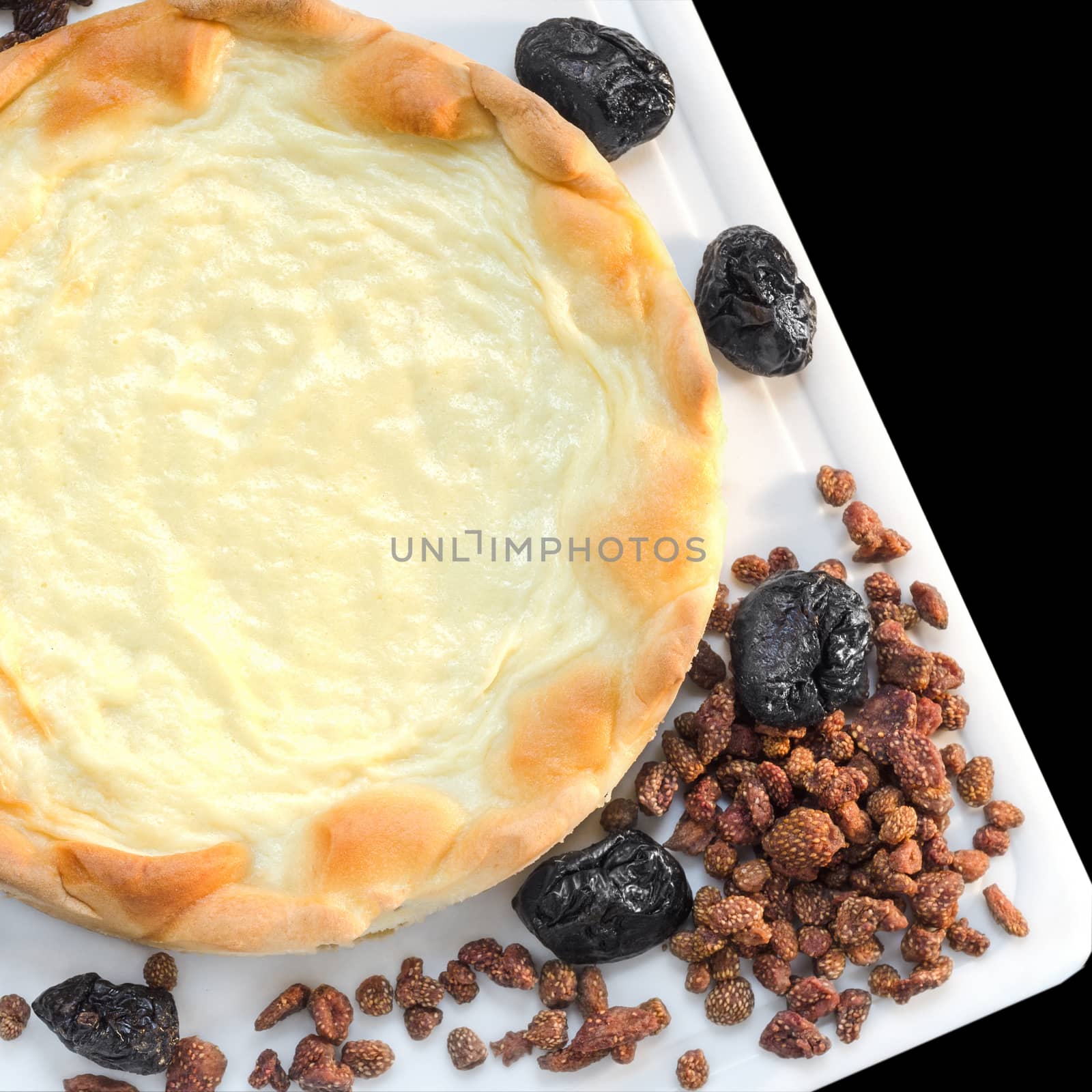 Cream pie and dried fruits on the table by Gaina