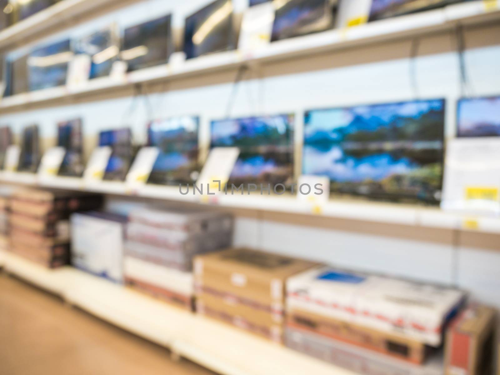 Blurred eletronic department store with television shelf. Blurred background with bokeh