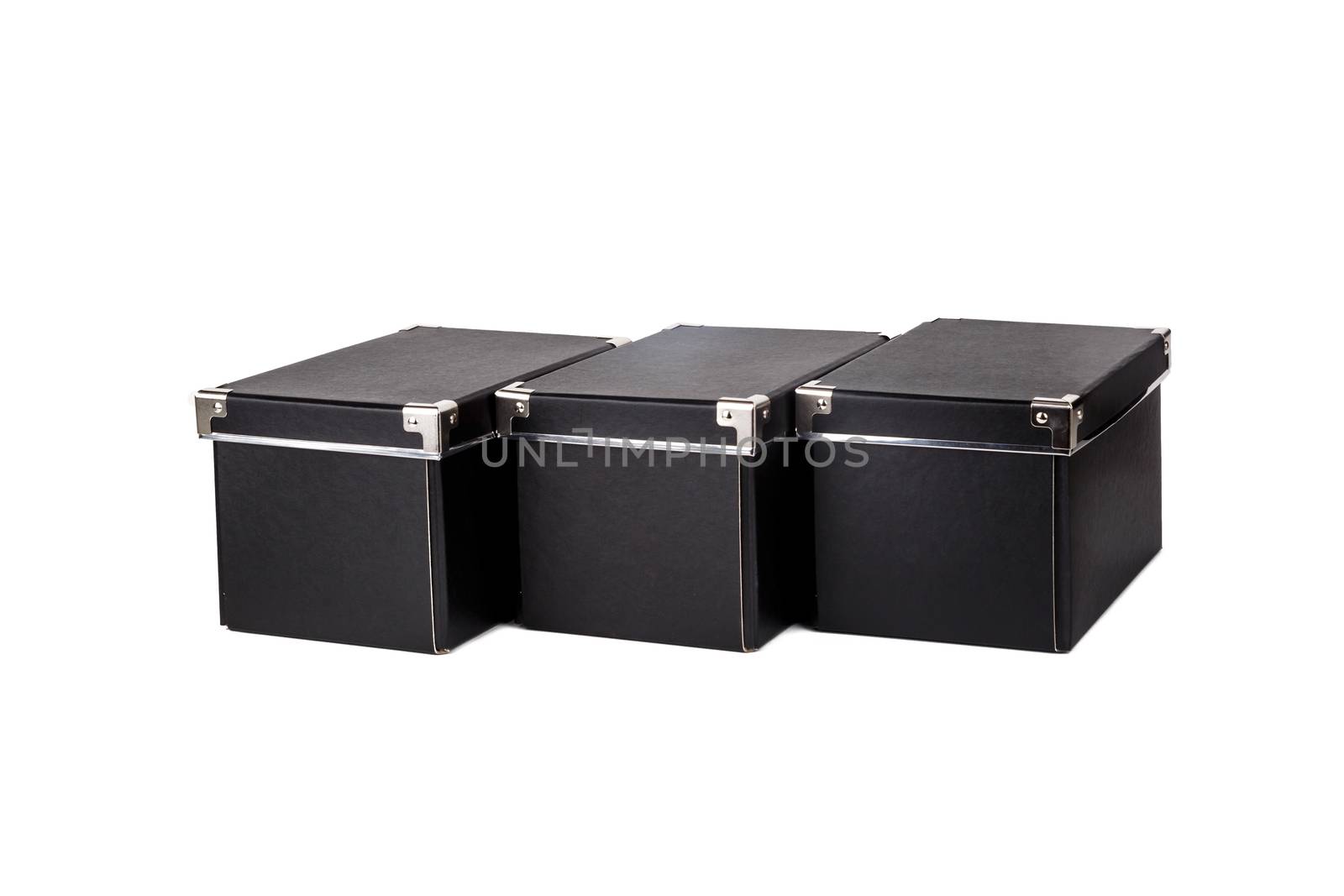 Close up view of three black cardboard box isolated on white background.