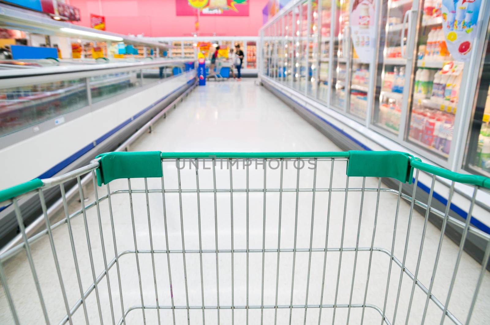 Abstract blurred photo of store with trolley in Supermarket stor by thampapon